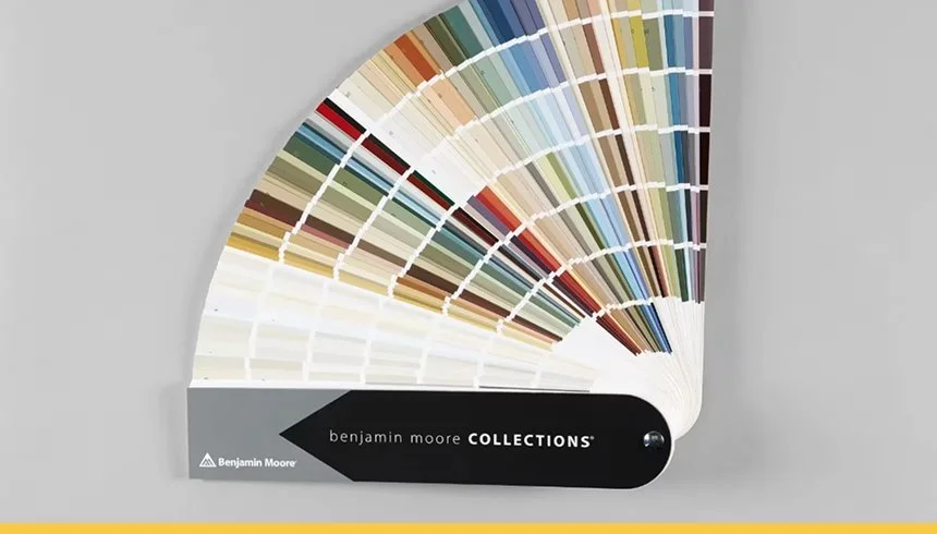 Color swatch fan deck with various shades and a black label reading "benjamin moore COLLECTIONS".