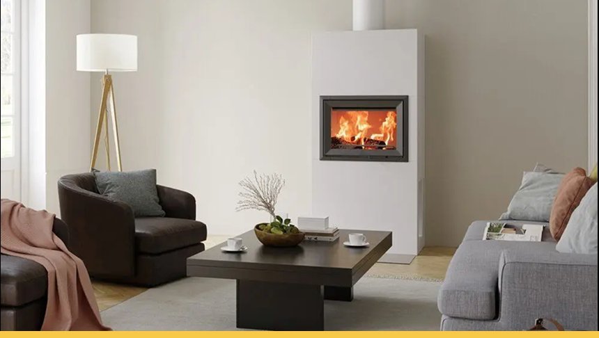 Living room with a modern fireplace, gray sofa, black armchair with pillow, wooden floor, white walls, a round wooden coffee table with a decorative bowl and books, a floor lamp, and a window with blinds.
