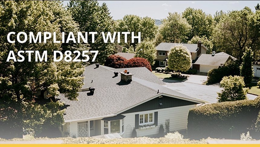 A neighborhood with houses surrounded by trees, with the text "Compliant with ASTM D8257" overlaid on the image.