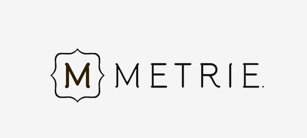 Logo with a stylized shield containing the letter 'M' and the word 'METRIE' next to it.