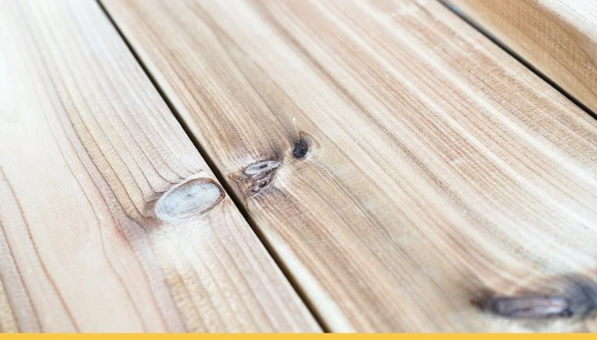 Close-up of wooden outdoor deck with visible wood grain and knots.