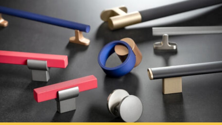 Various colorful pieces of jewelry, including rings and bars, scattered on a black surface.