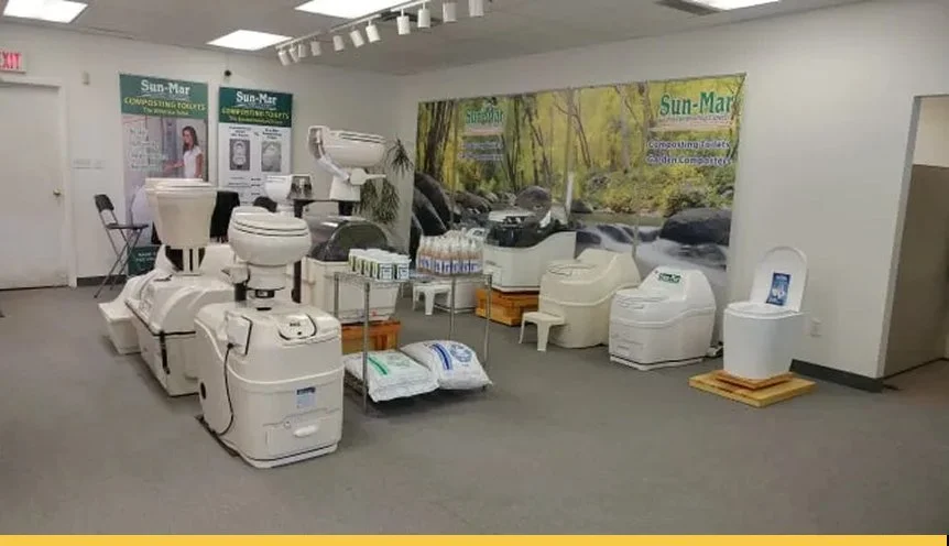 Display of various water treatment and filtration equipment in a showroom, with promotional banners and a nature-themed backdrop.