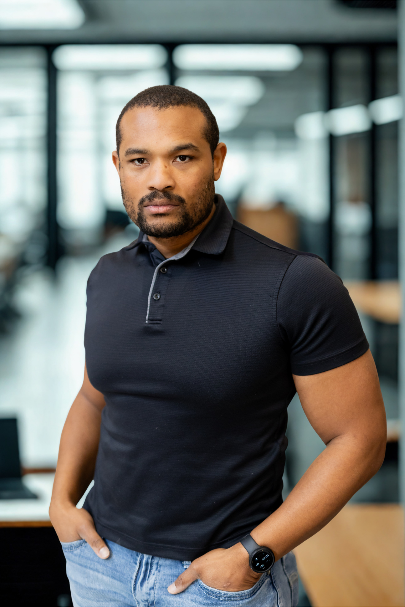 Rashard King, Fractional Chief Development Officer at Praxis Protocol Consulting, standing in a modern corporate setting.