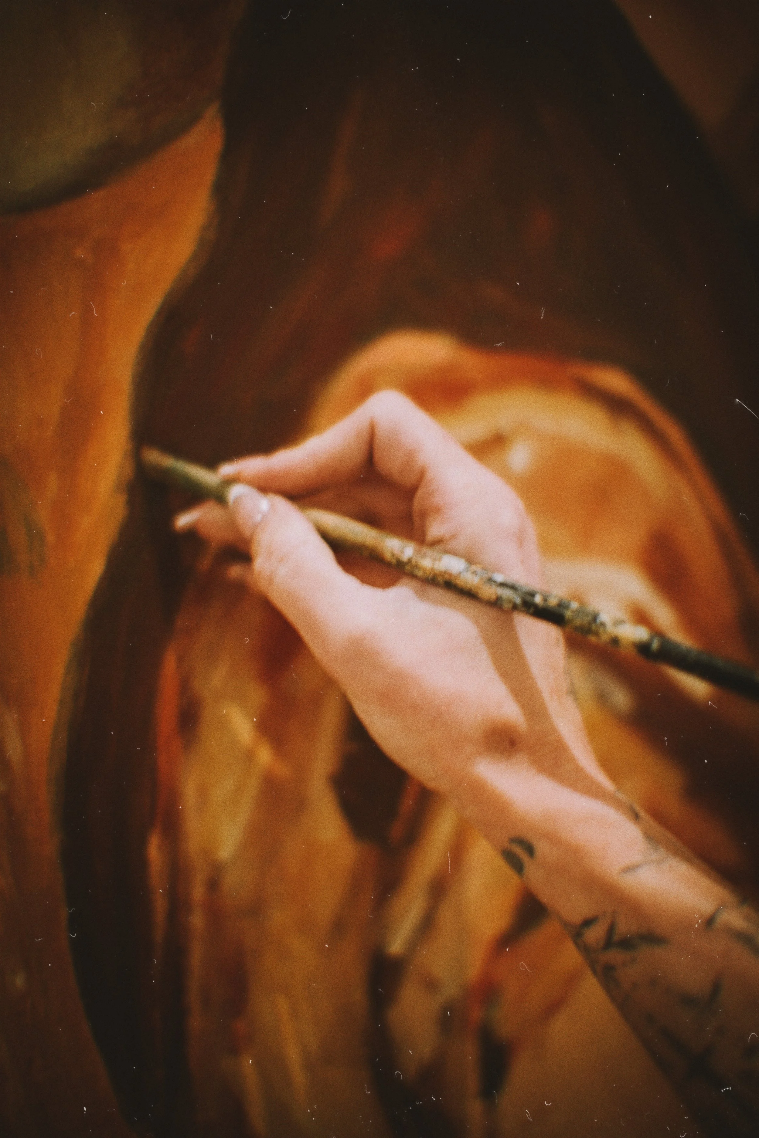 A person painting a realistic portrait of a horse with warm, earthy colors in a detailed, artistic style.