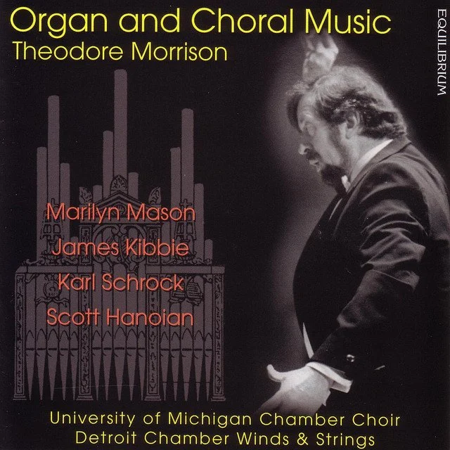 Album cover titled "Organ and Choral Music" by Theodore Morrison, featuring a black-and-white photograph of a man with long hair and a beard, looking down. The cover lists performers Marilyn Mason, James Kibbie, Karl Schrock, and Scott Hanian, along with the University of Michigan Chamber Choir and Detroit Chamber Winds & Strings, with a graphic outline of an organ in the background.