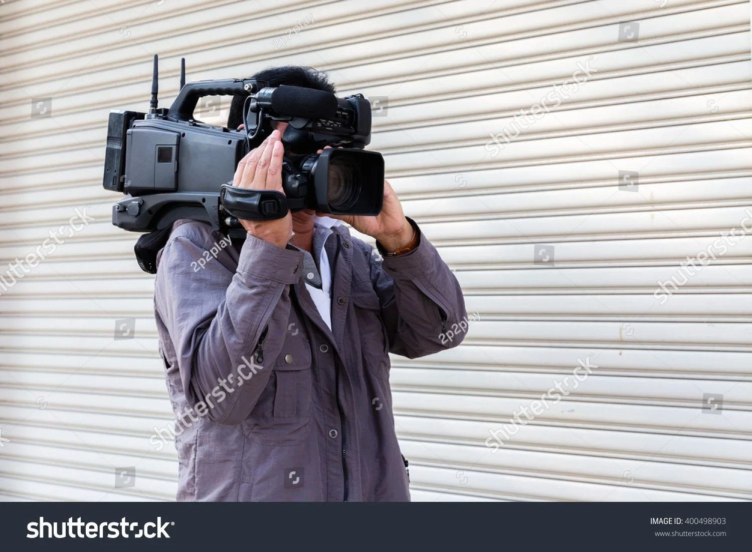 stock-photo-news-cameraman-broadcasting-filming-outdoor-event-400498903.jpg