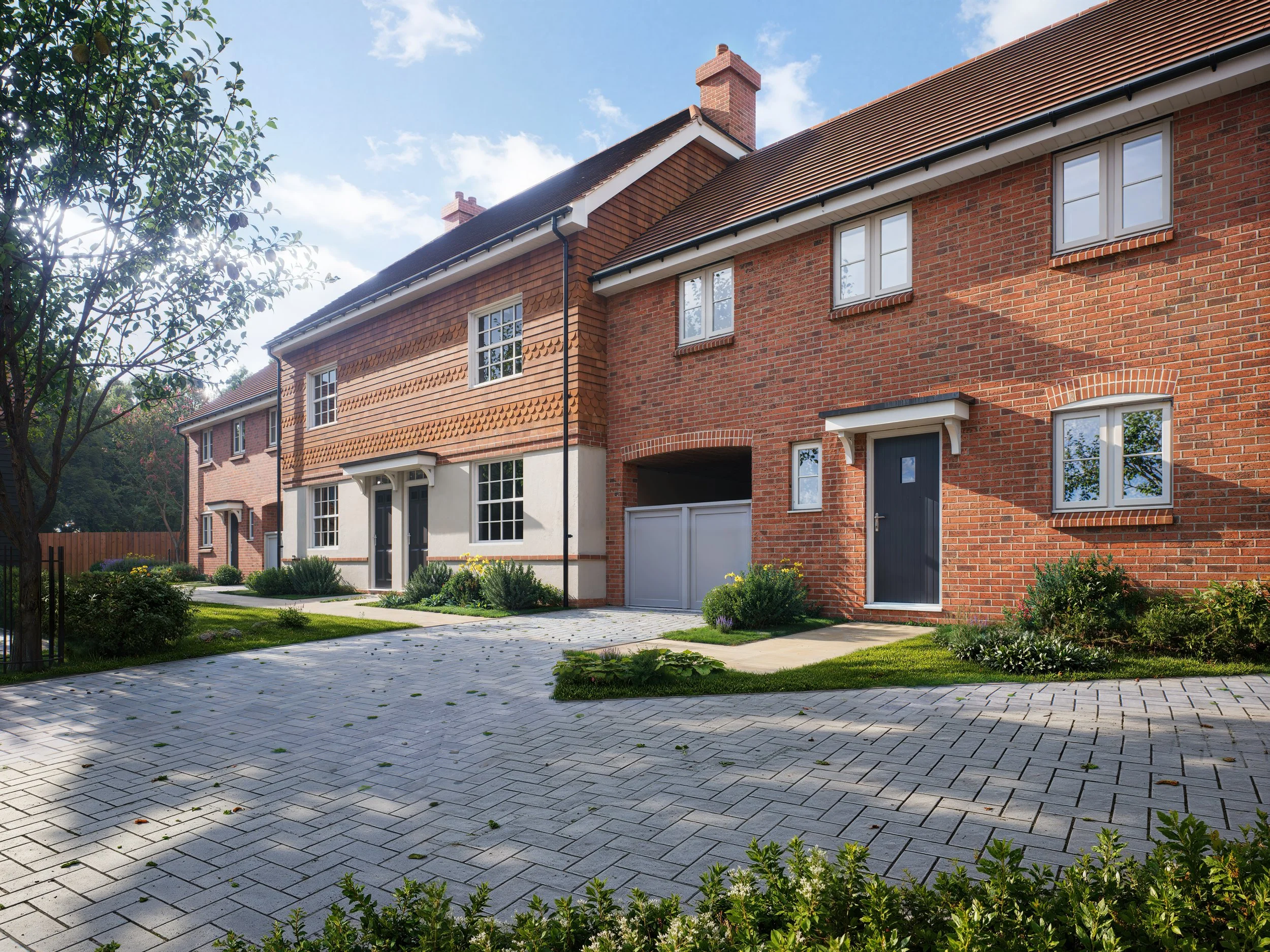 Row of brick townhouses on a sunny day with a sidewalk and small landscaped front yards.