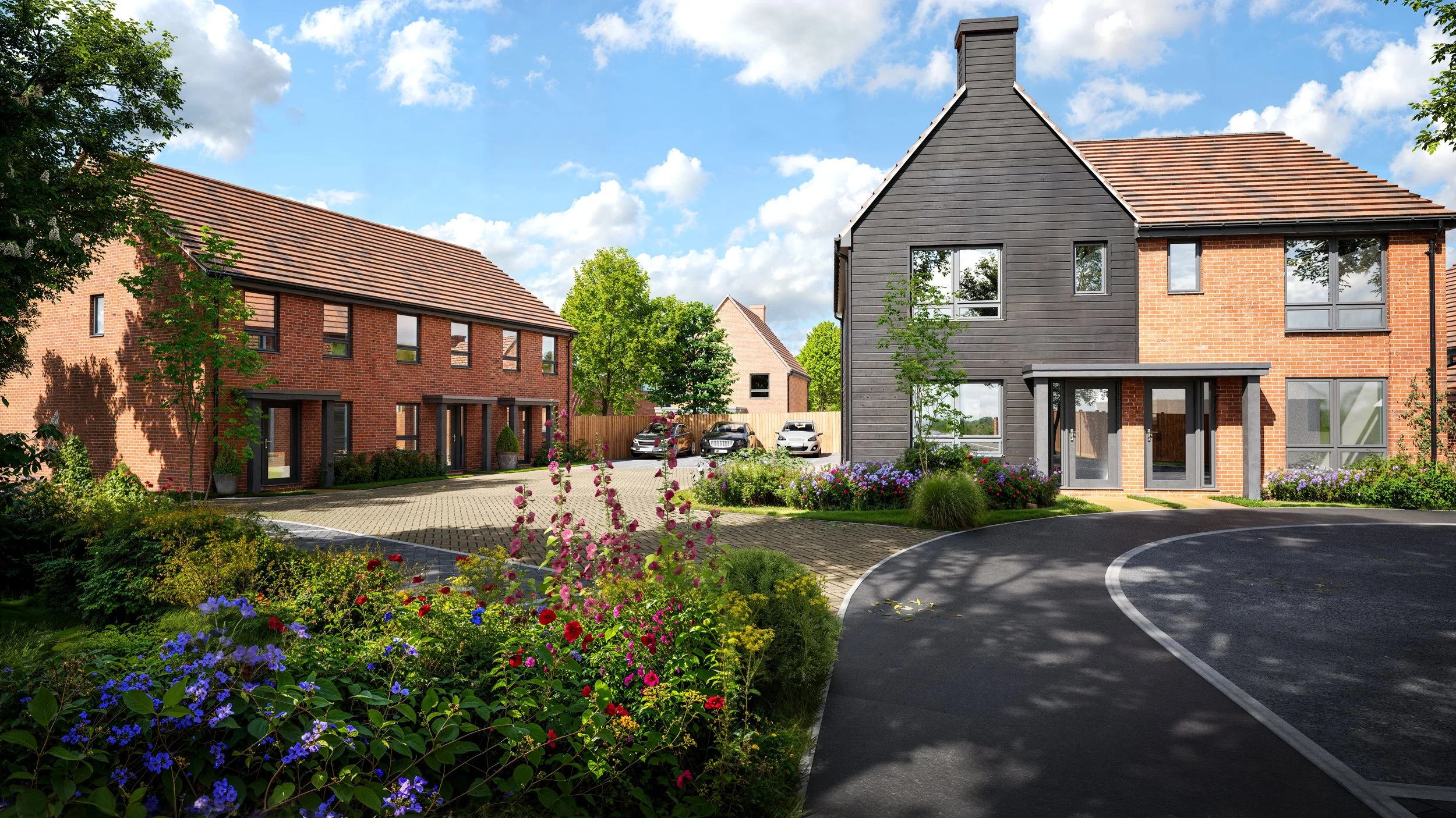 A residential neighborhood with modern brick and wooden houses, a curved driveway, well-maintained gardens with colorful flowers, and parked cars under a bright blue sky with scattered clouds.
