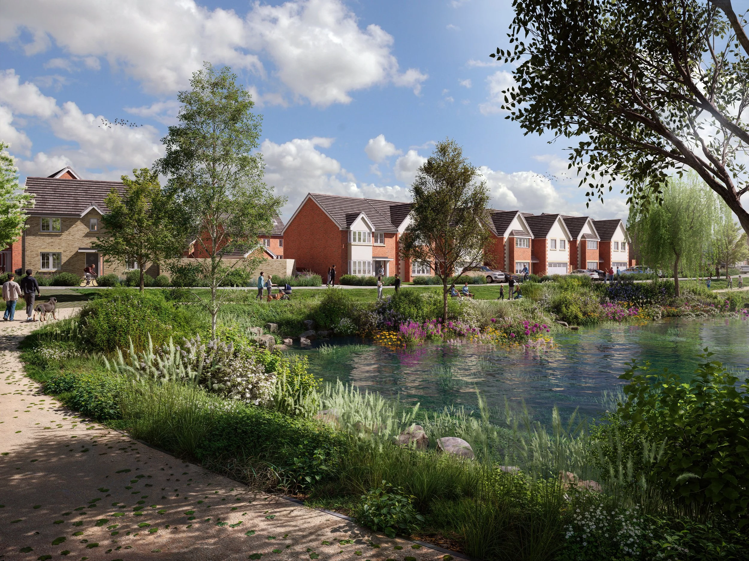 A scenic park with walking paths, lush greenery, and colorful flowers beside a pond, with residential houses and a blue sky with clouds in the background.