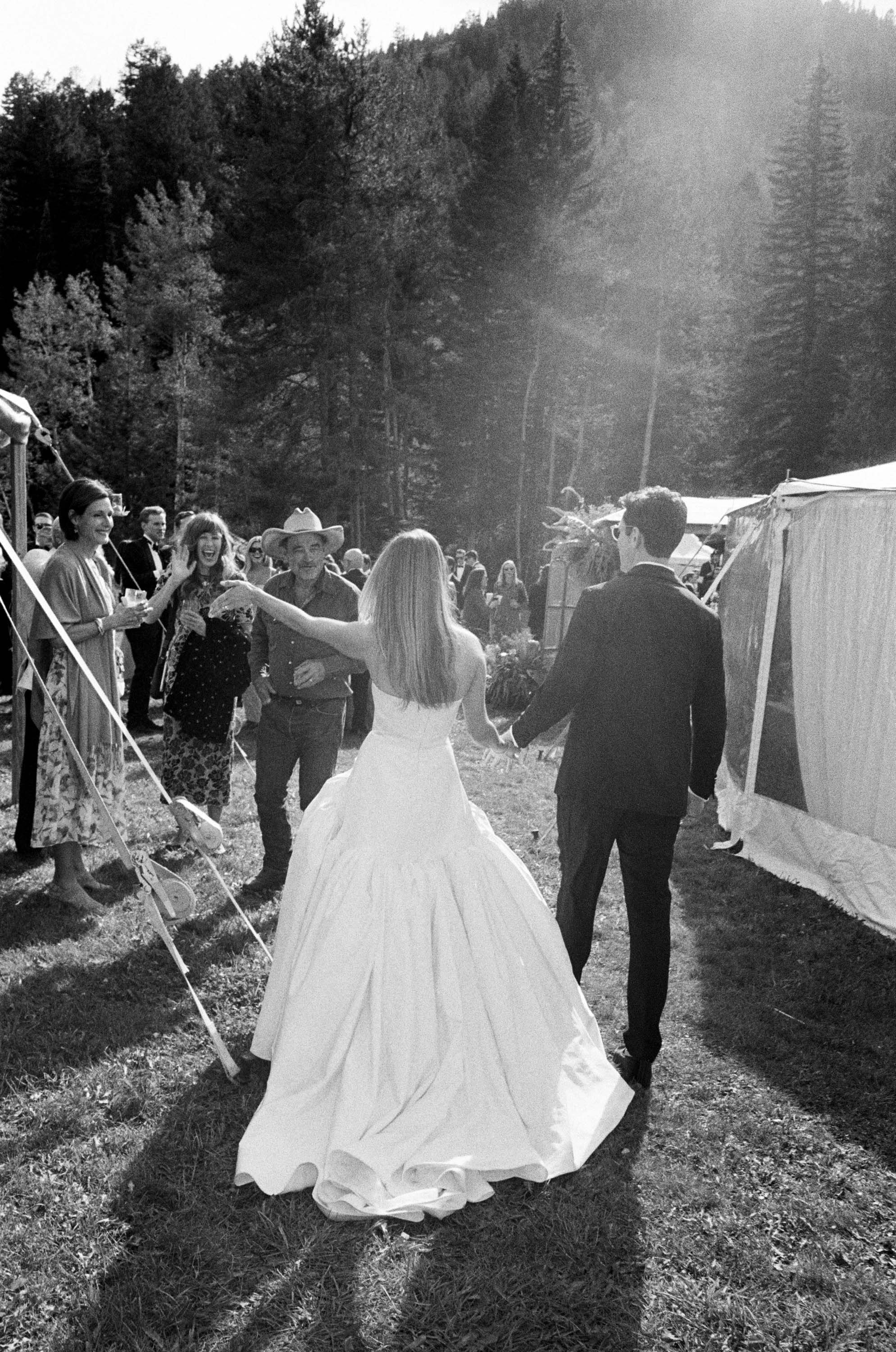 a bride and groom walking to friends and family at their wedding in vail colorado