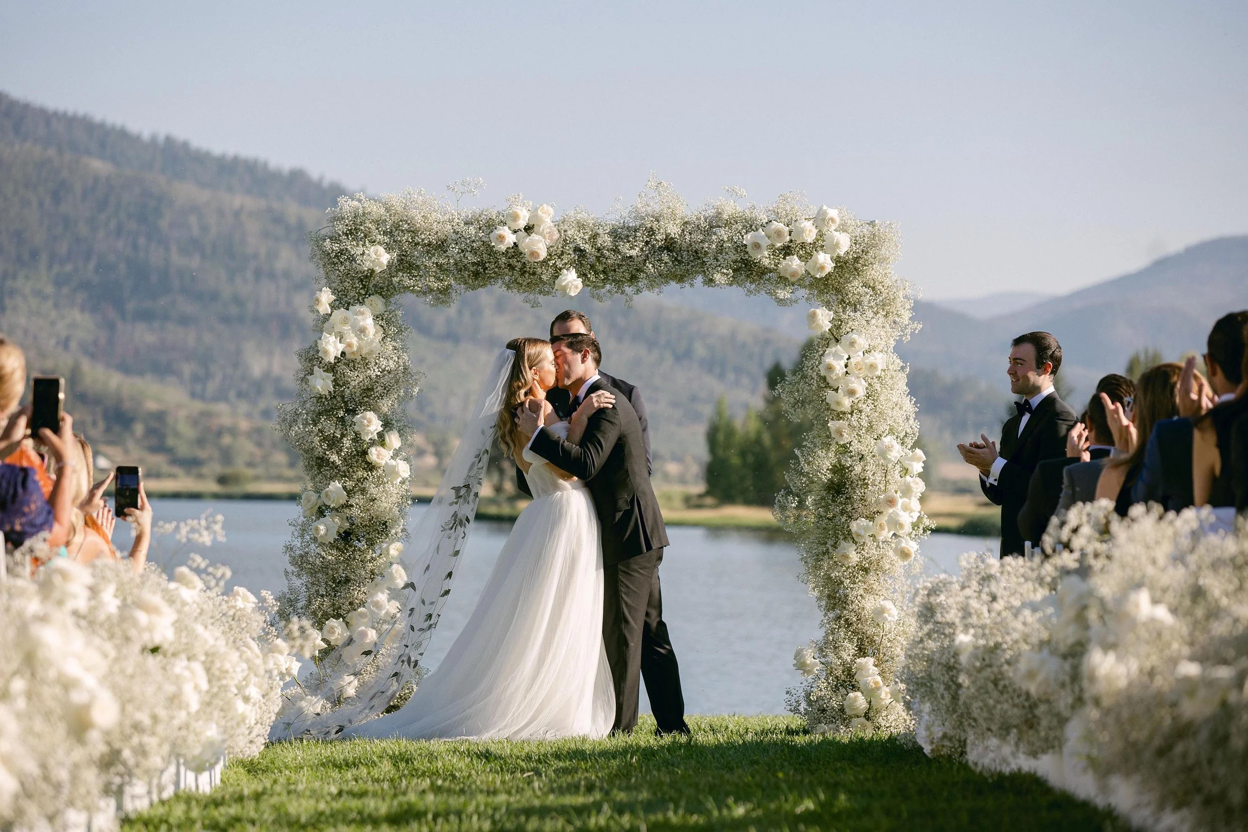 a bride and groom sharing their first kiss as newlyweds in beaver creek colorado
