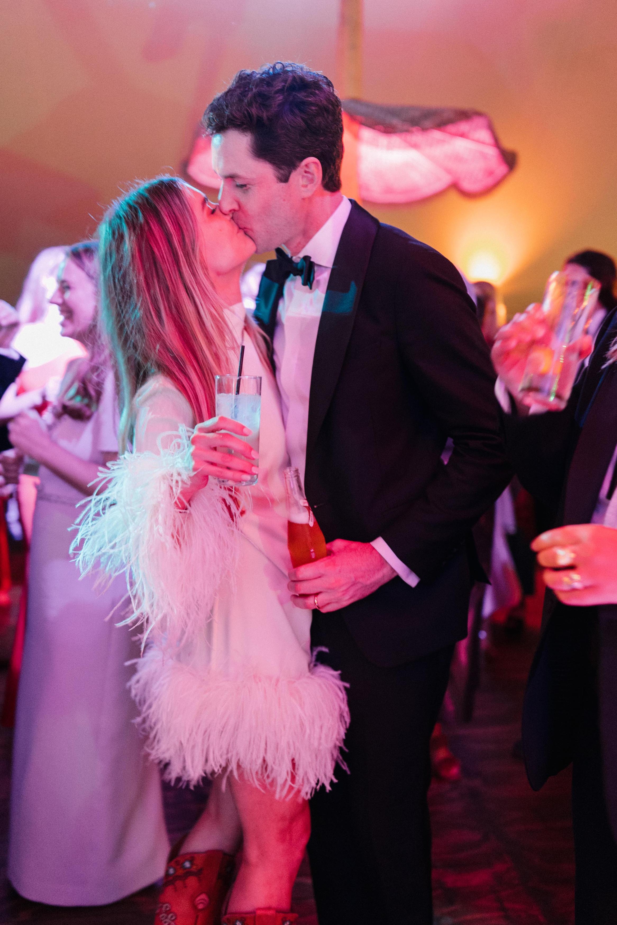 a bride and groom kissing each other on the dance floor after their wedding in vail colorado