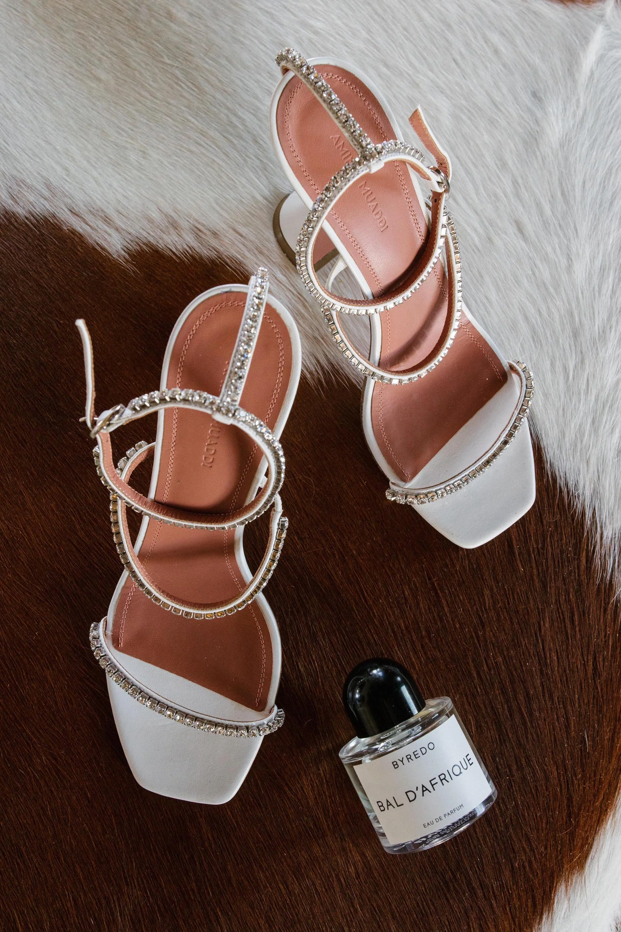 crystal embedded white heeled shoes and perfume for the bride