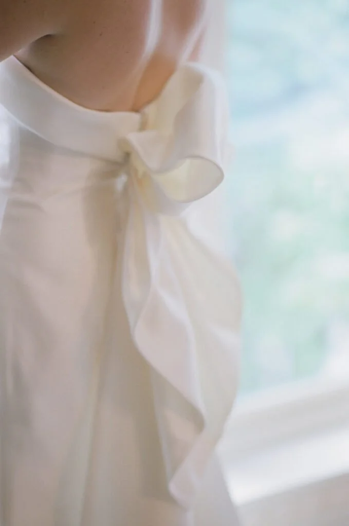 Back of an elegant wedding gown with a silk bow, perfect for brides who just got engaged.
