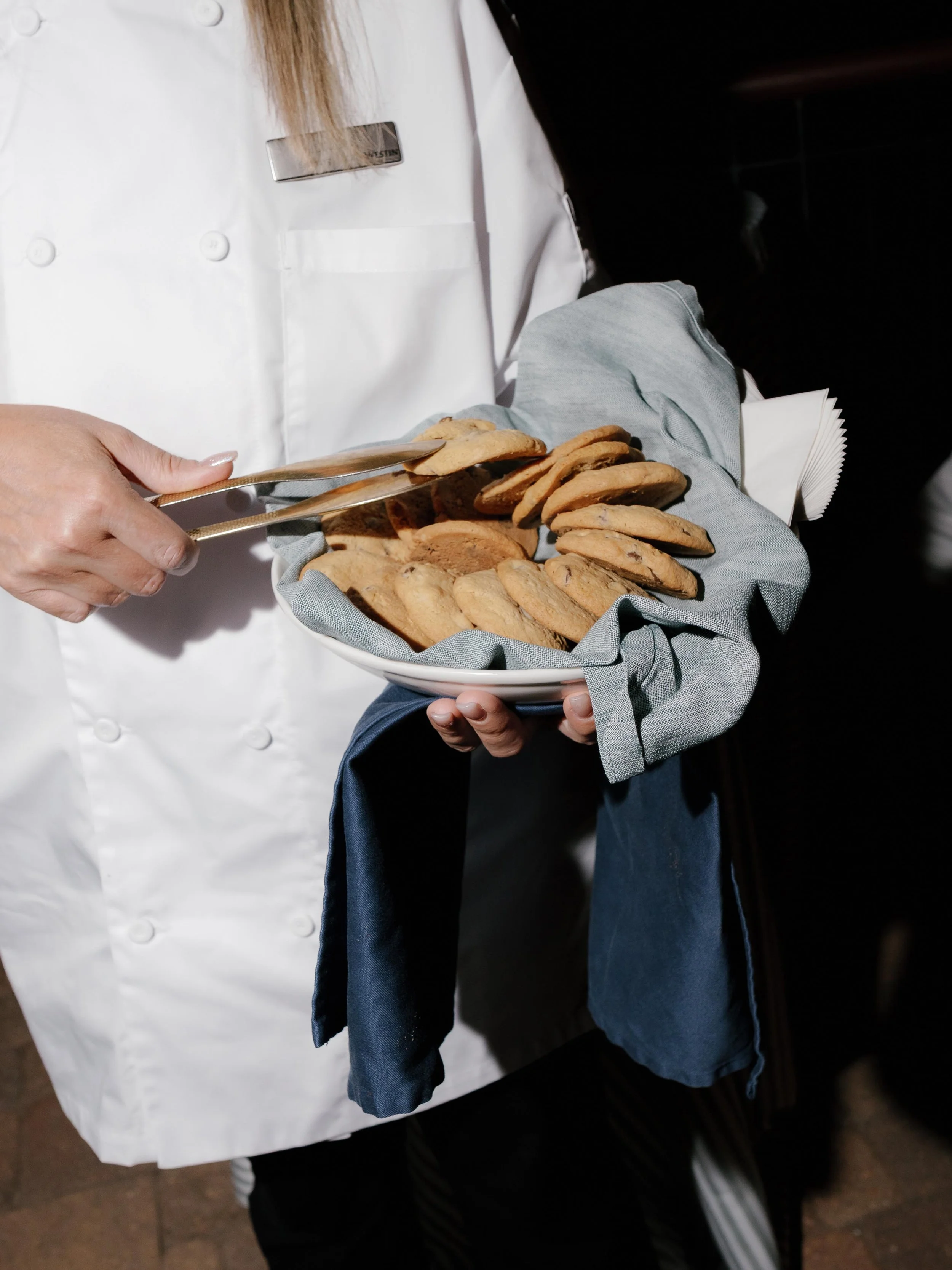 expert caterer distributing cookies to wedding guests