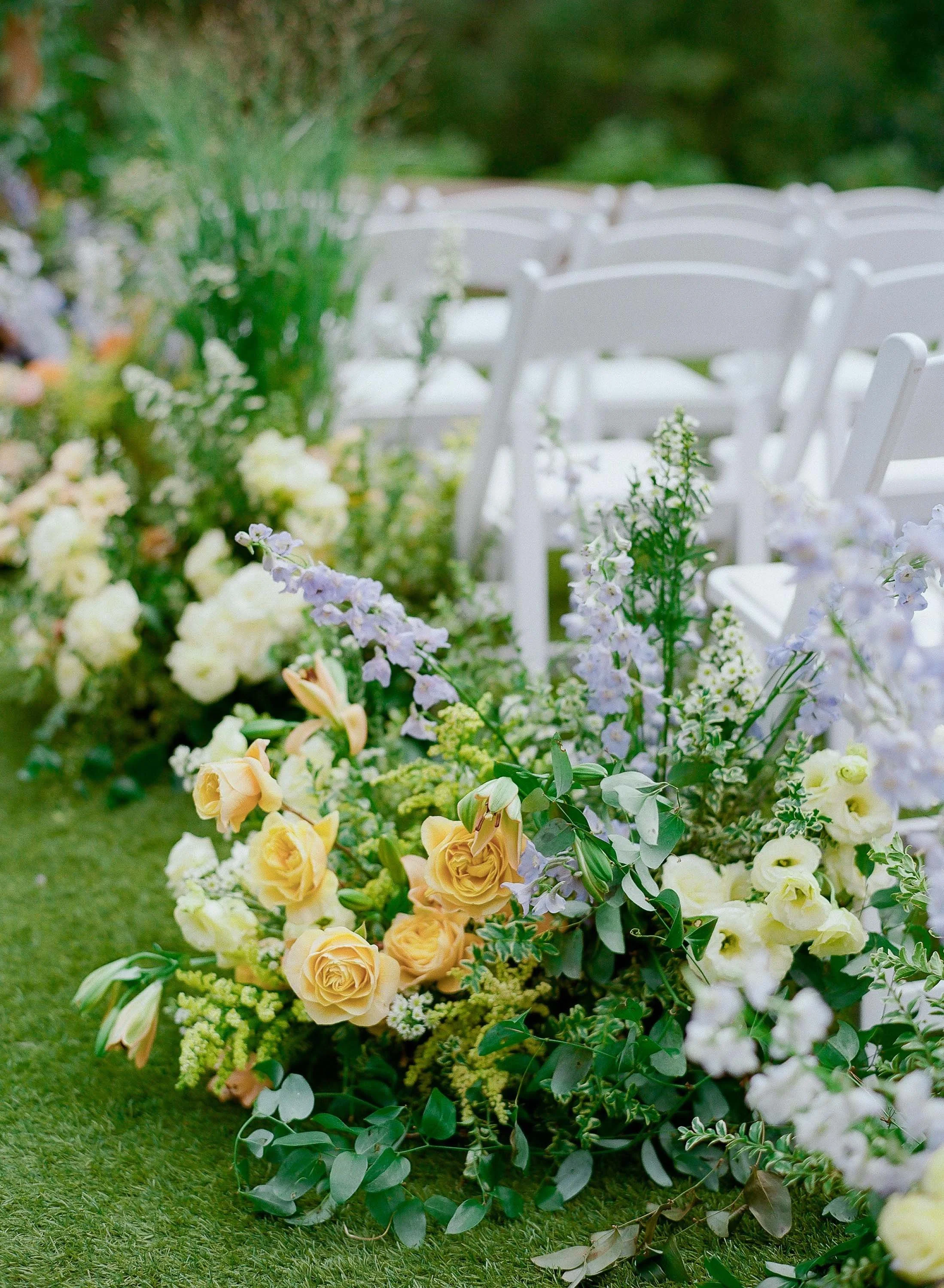 bespoke orange and purple floral arrangement for outdoor full service colorado wedding