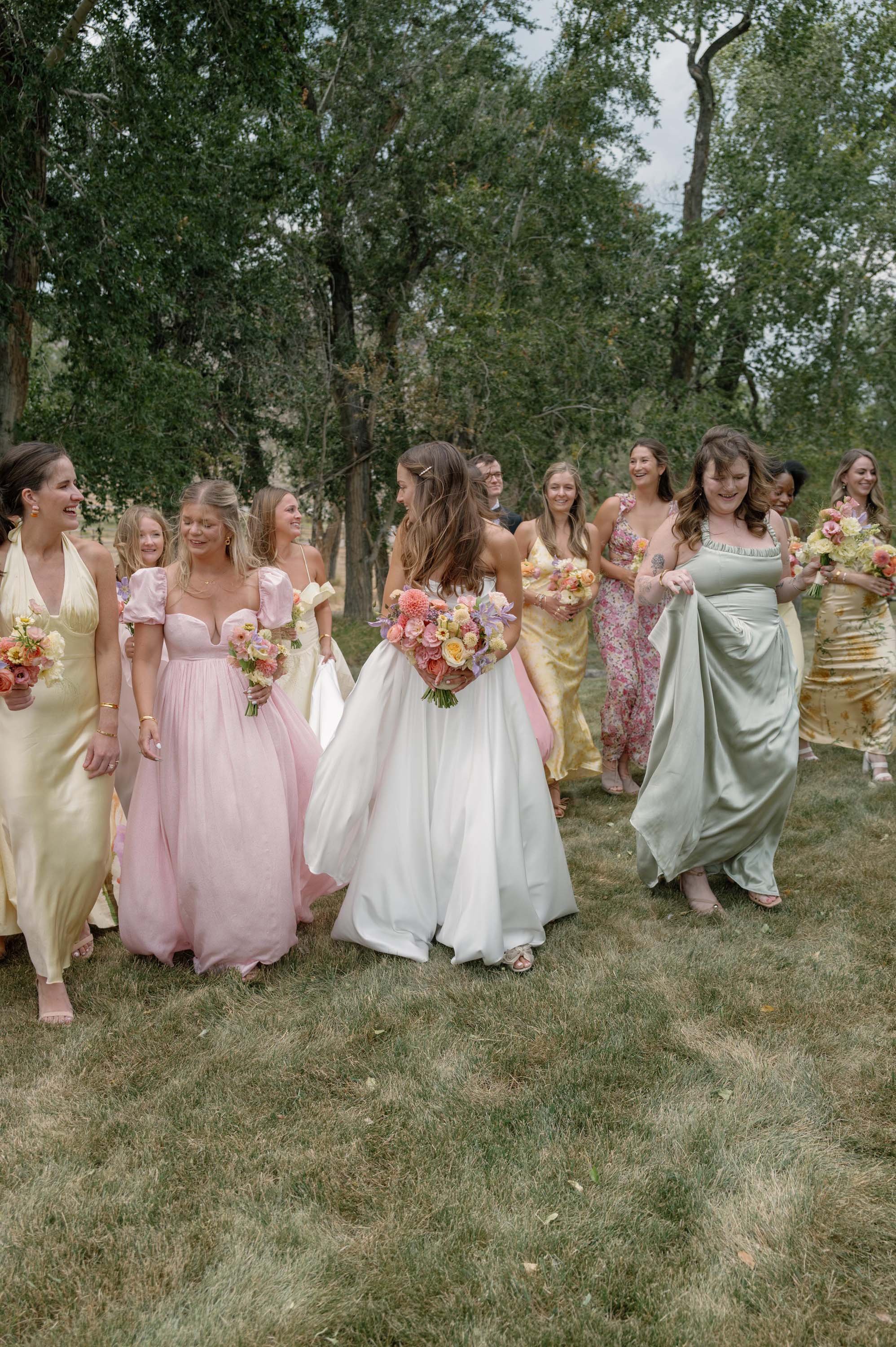 a bride and her bridesmaids laughing and chatting together