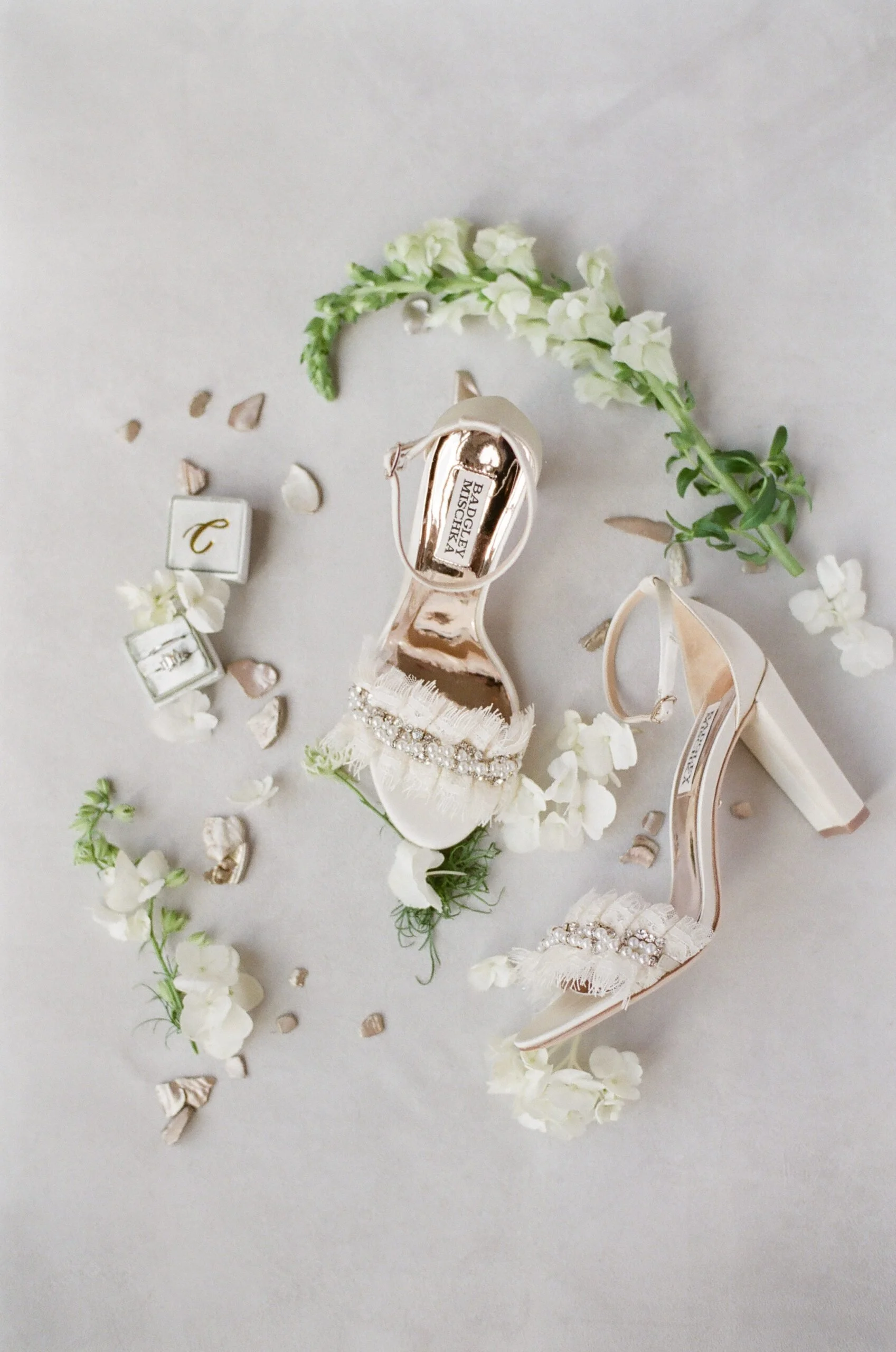 wedding details of brides shoes, ring, and florals while planning a destination wedding in New England