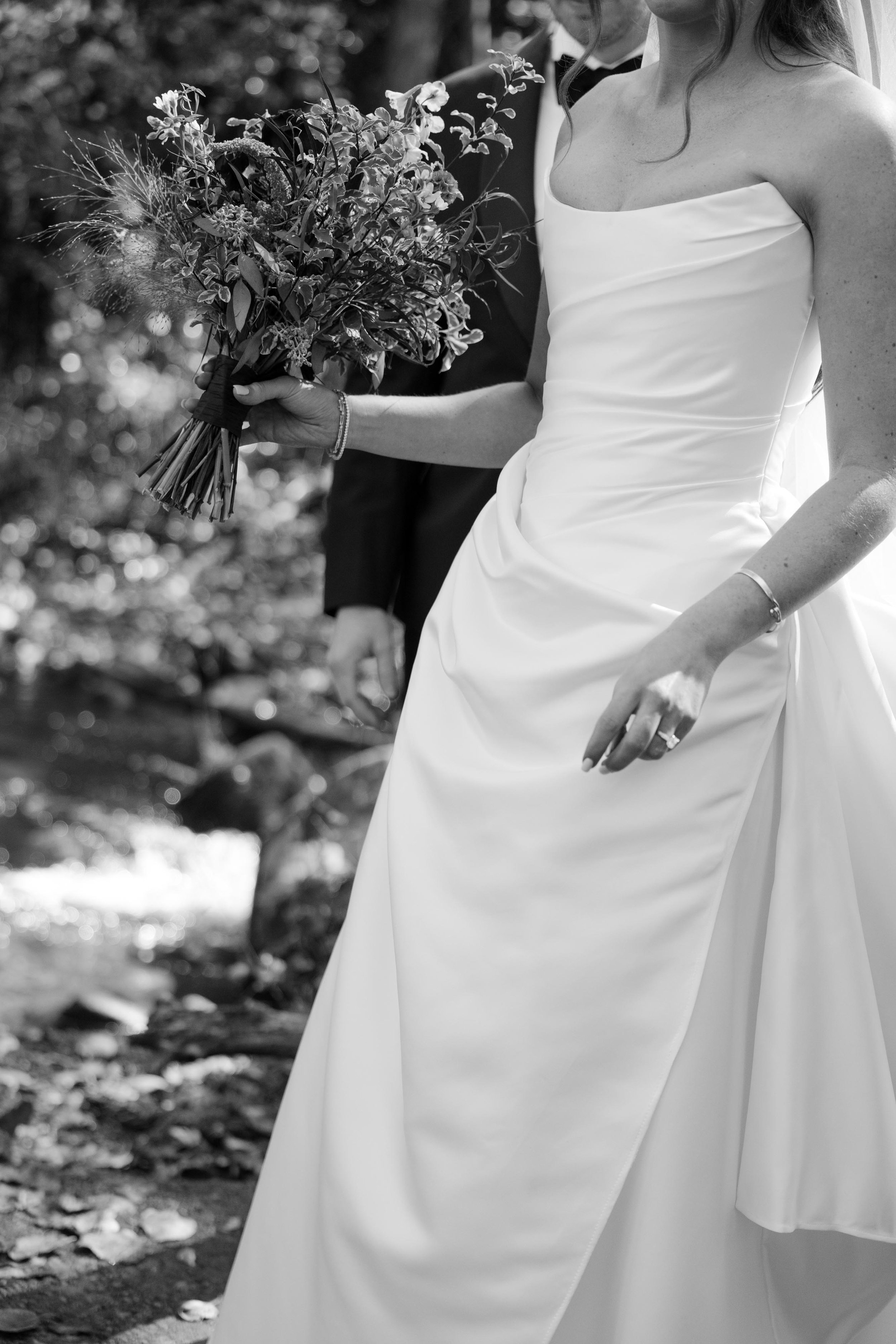 a modern bride holding flowers and walking outside