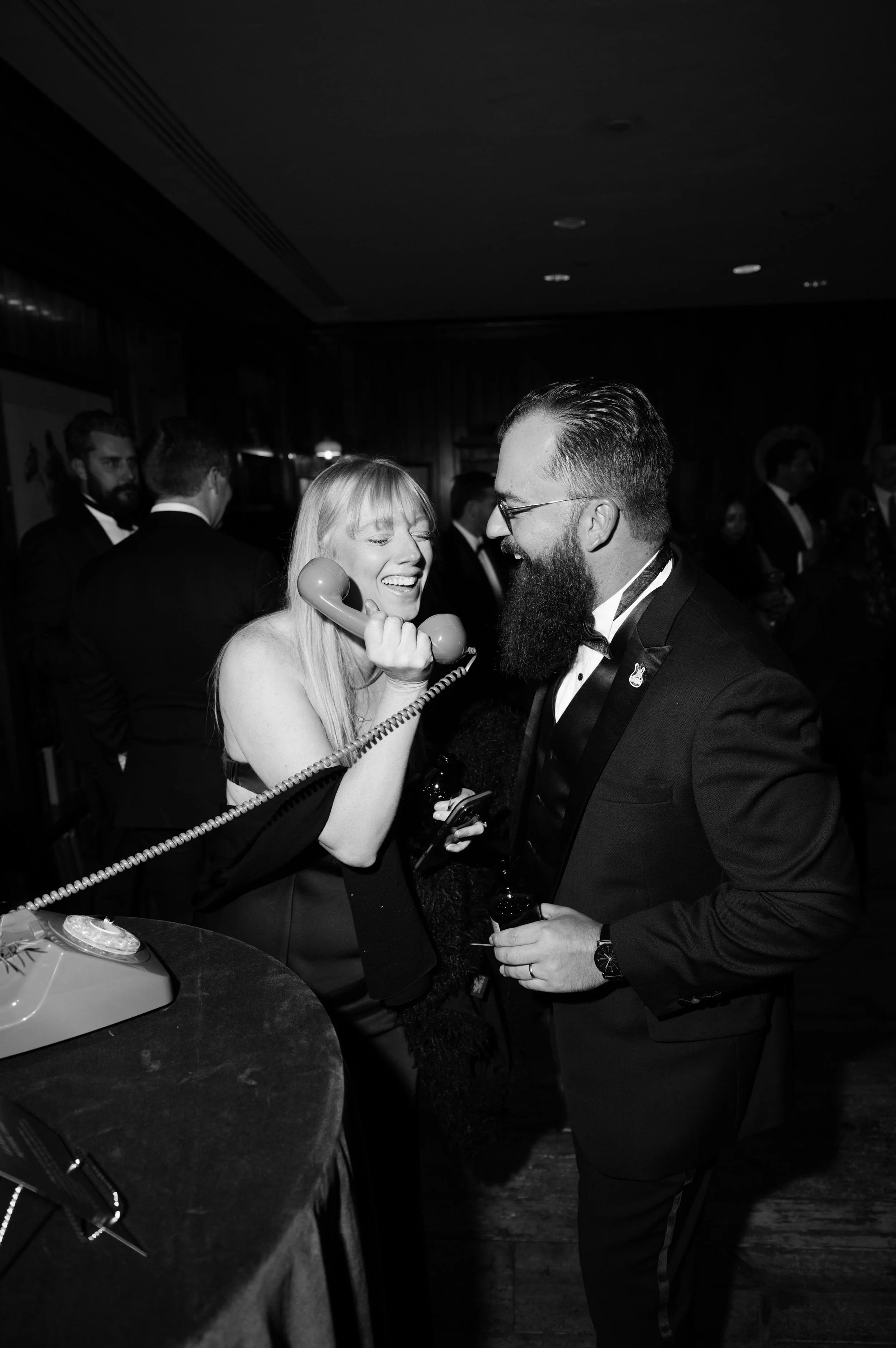 friends and family of a bride and groom having fun with props set up on the dance floor
