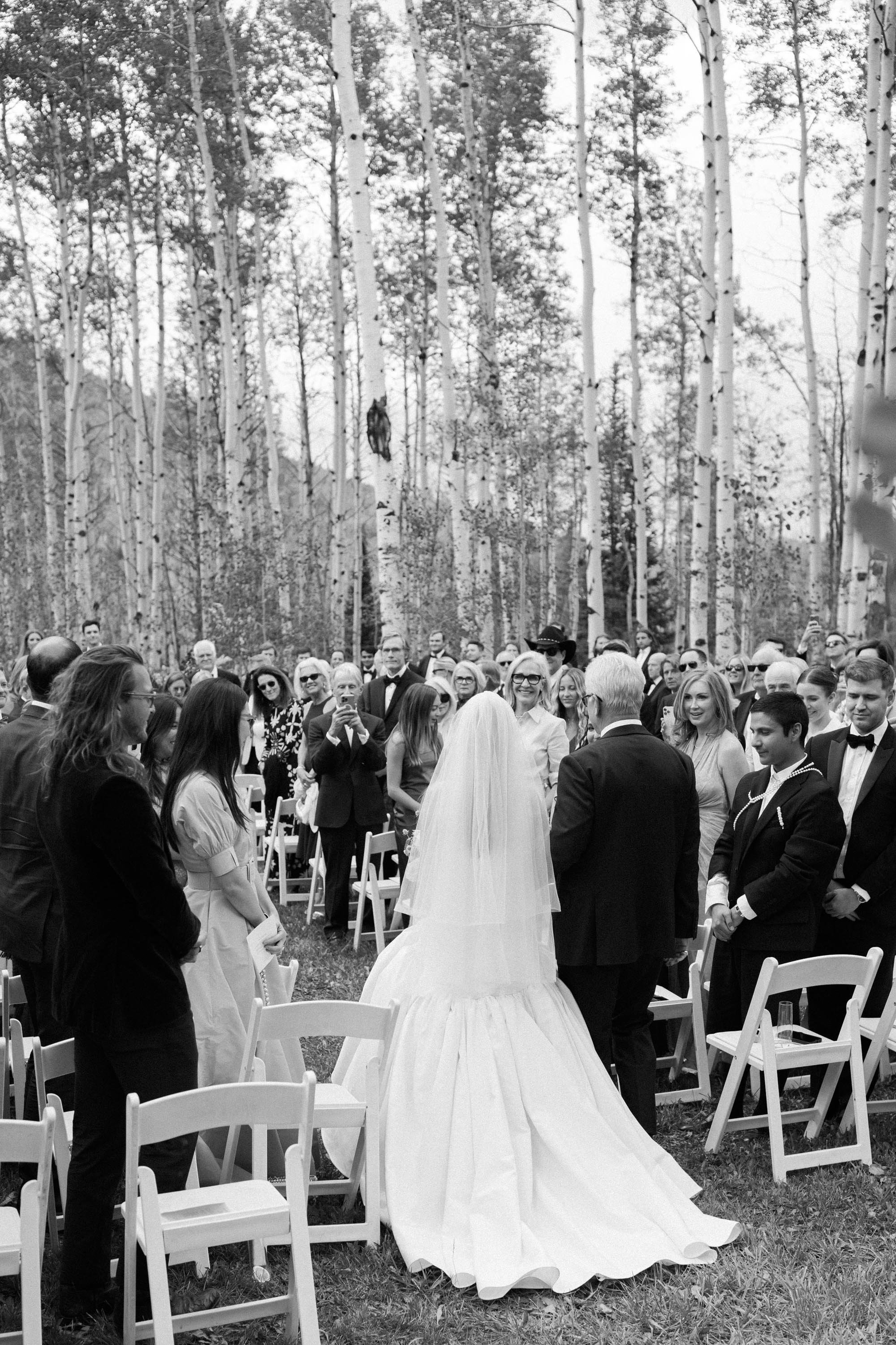 the bride and her father walking down the aisle to the altar
