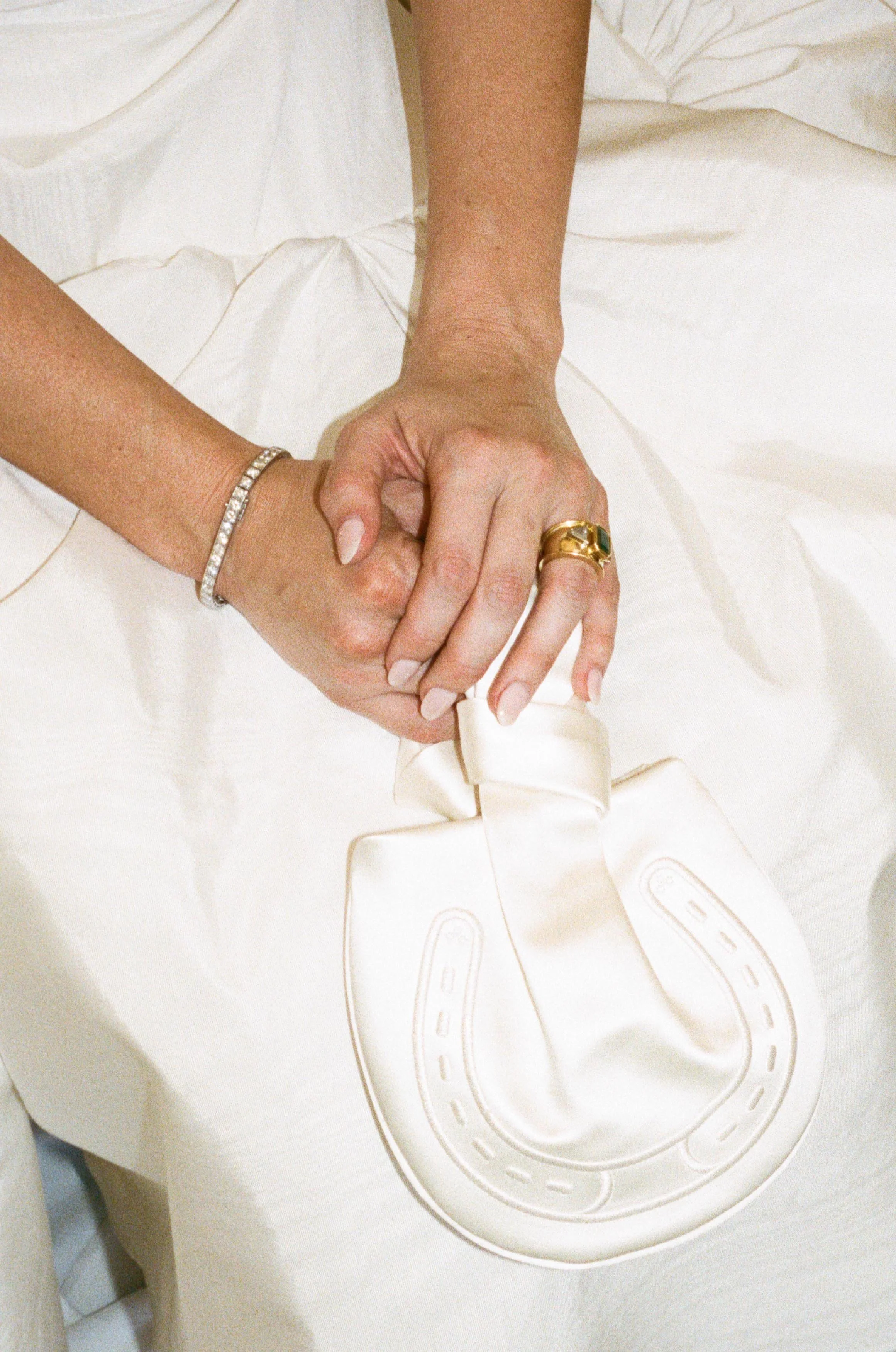 a custom horseshoe purse that a bride is wearing
