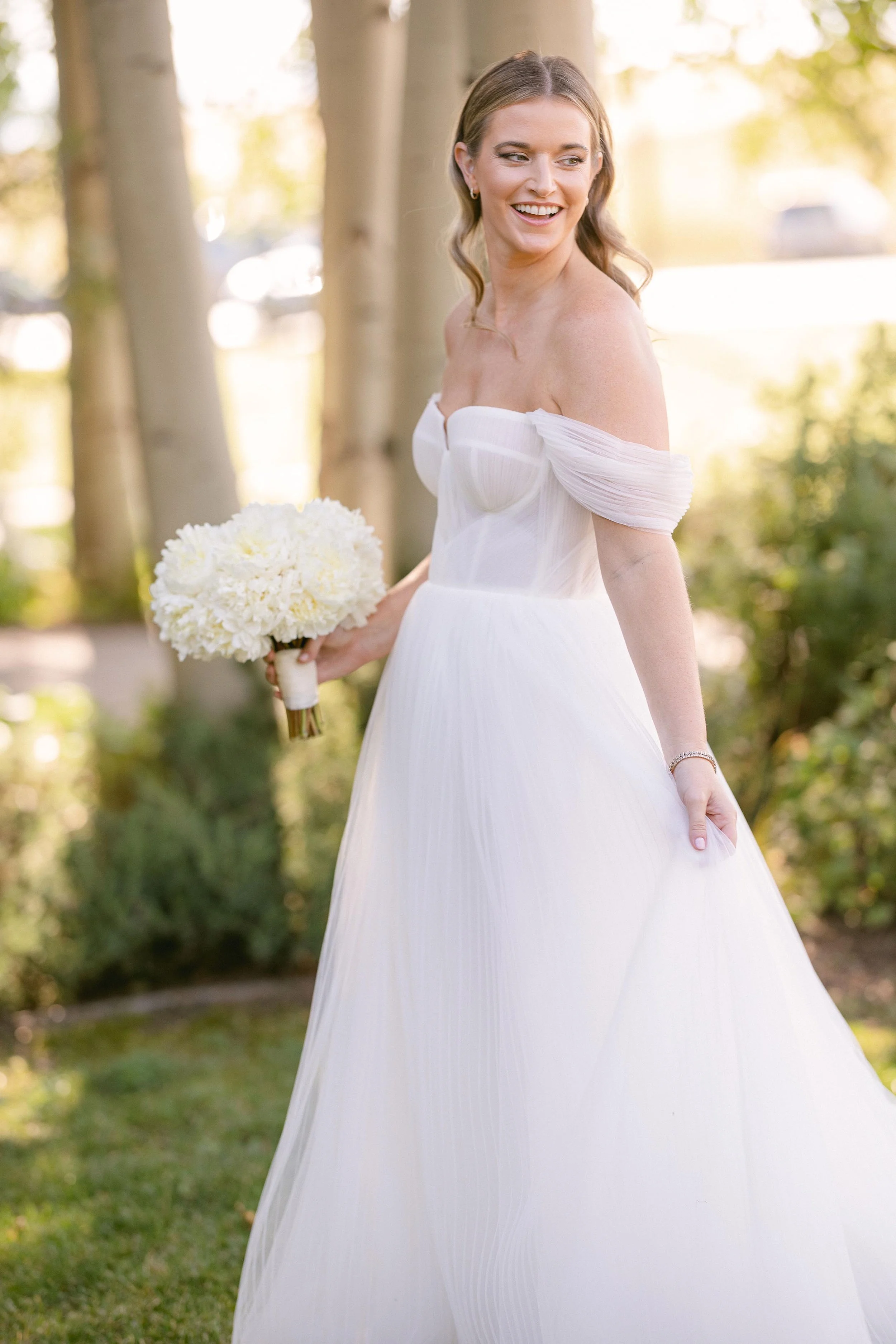 a beautiful bride posing with her flower bouquet in steamboat springs colorado