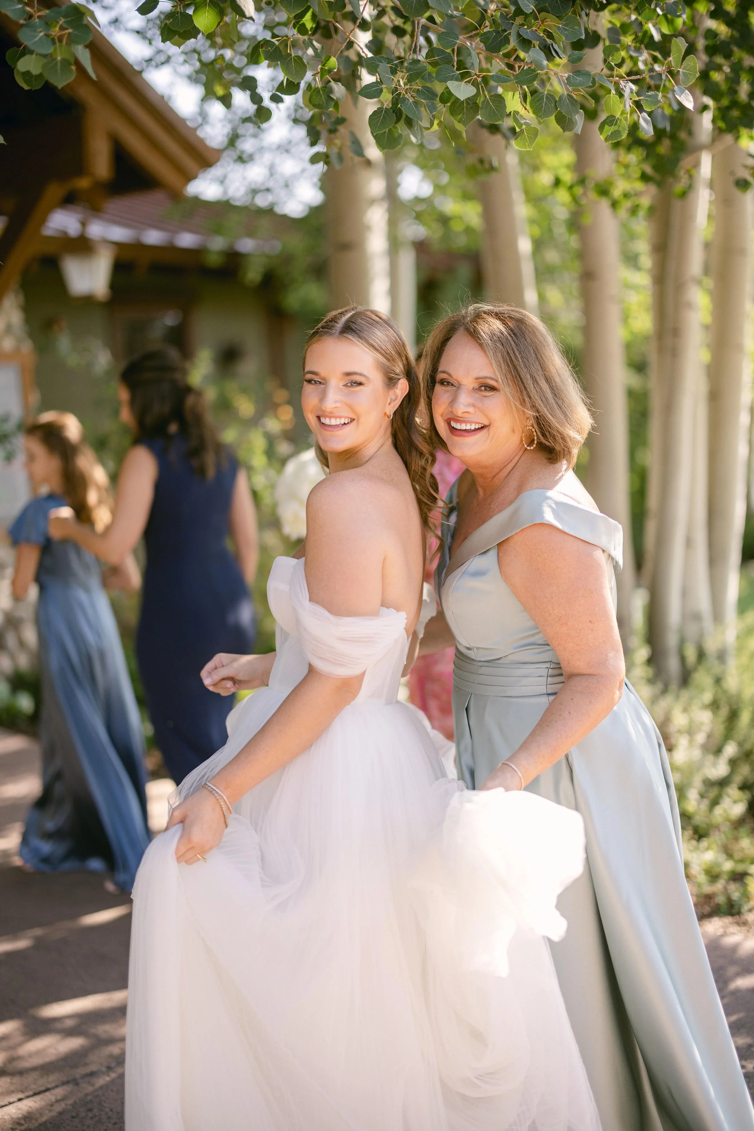 a bride and her mom posing together on her wedding day in steamboat springs colorado