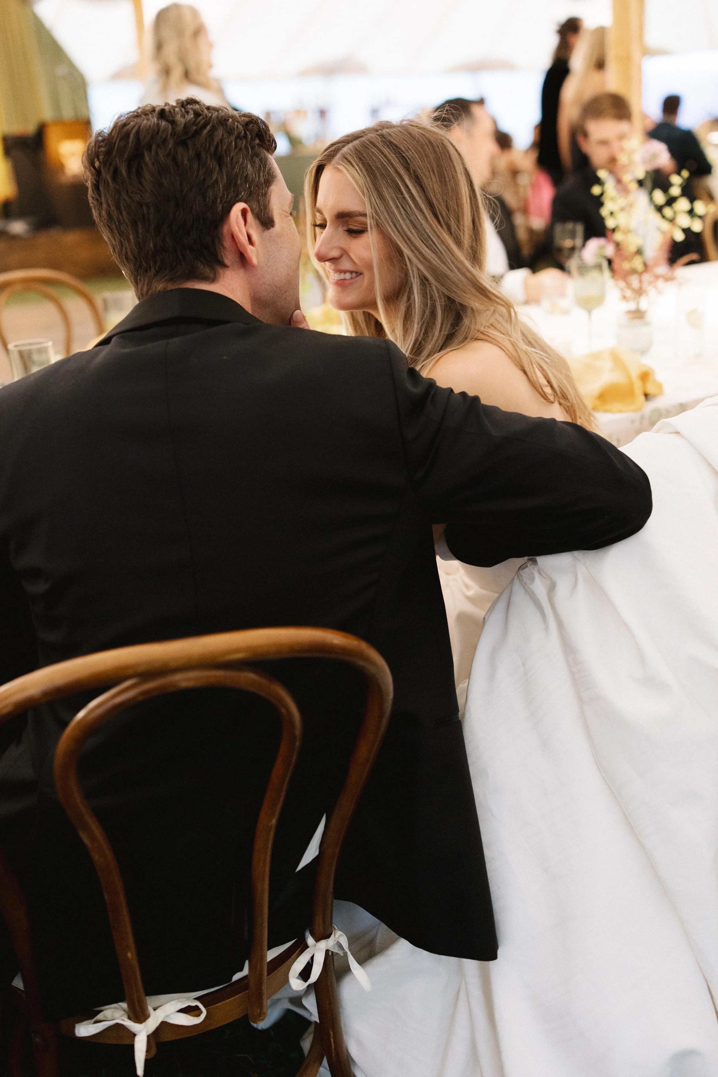 a bride and groom looking at each other lovingly at their rehearsal dinner in vail colorado