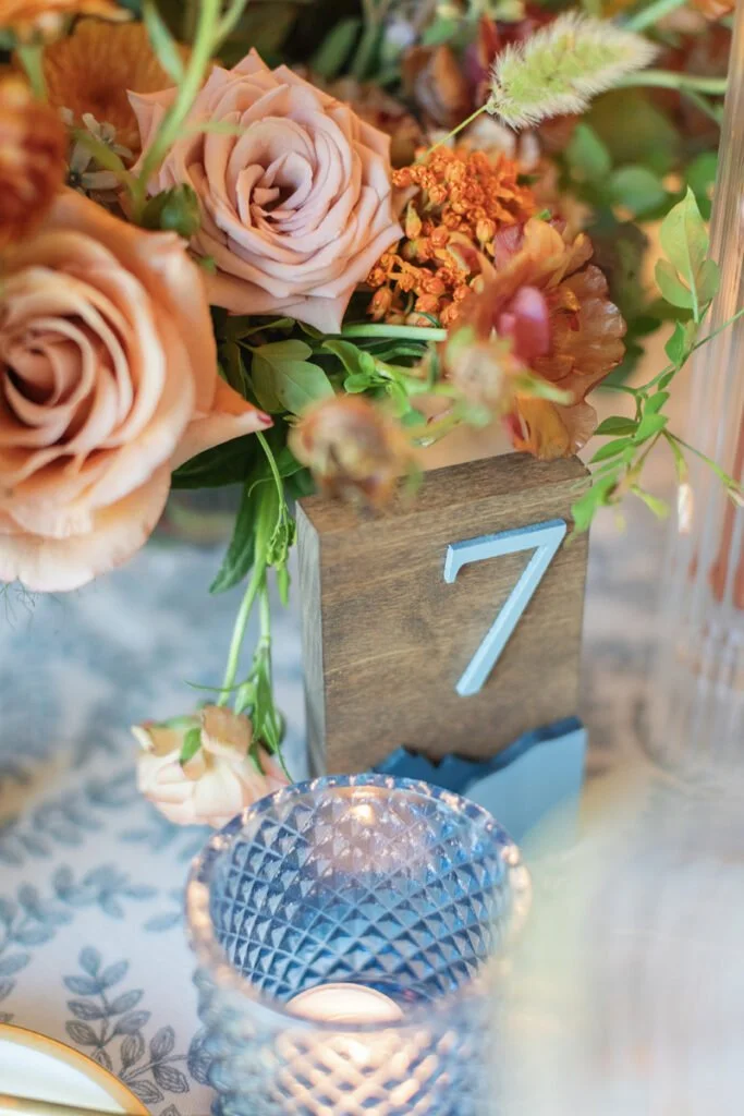 Spring wedding color palettes with blush, apricot florals and elegant rings styled on soft neutral background