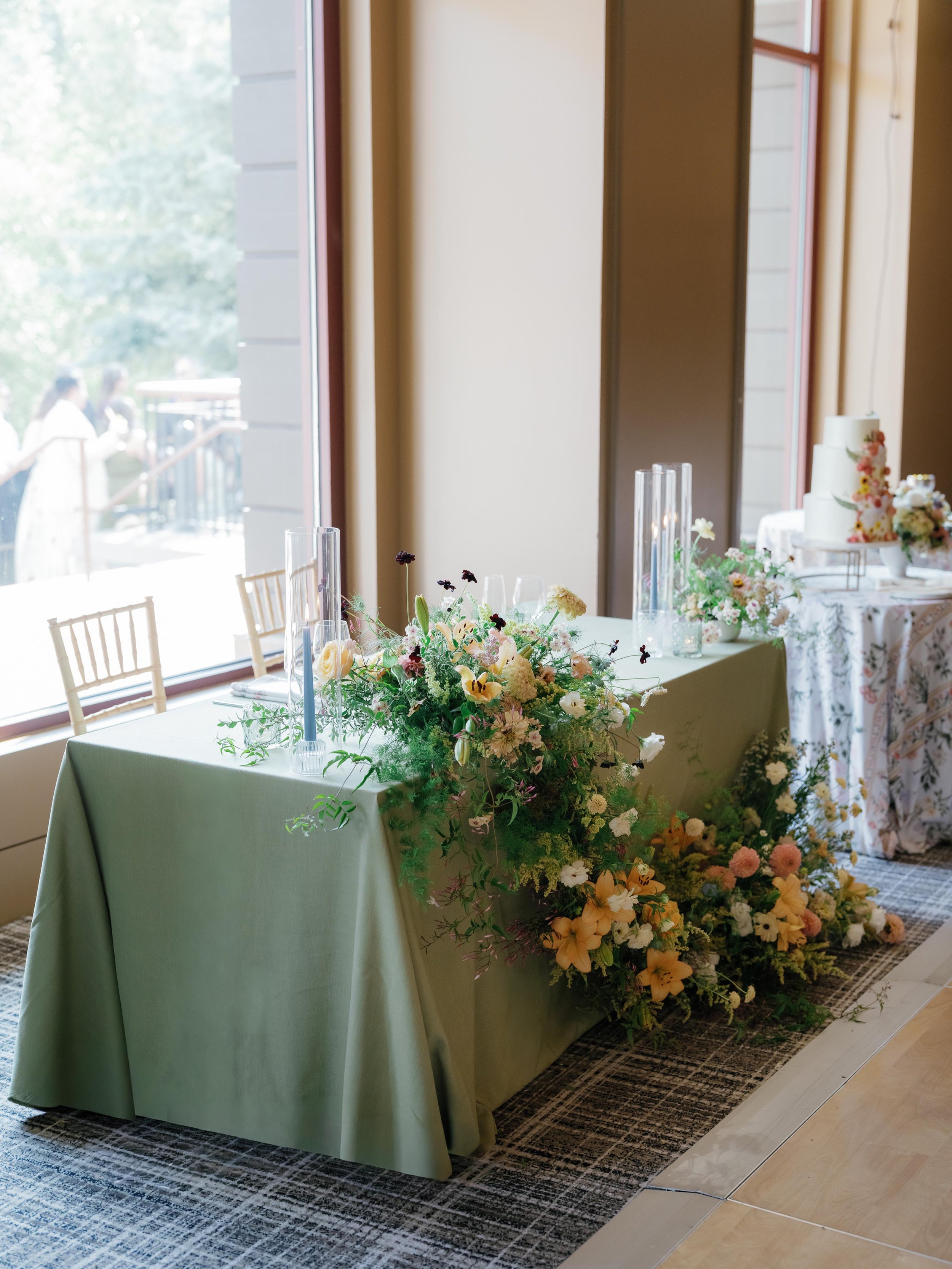custom floral arrangement for the bride and groom dinner table indoors