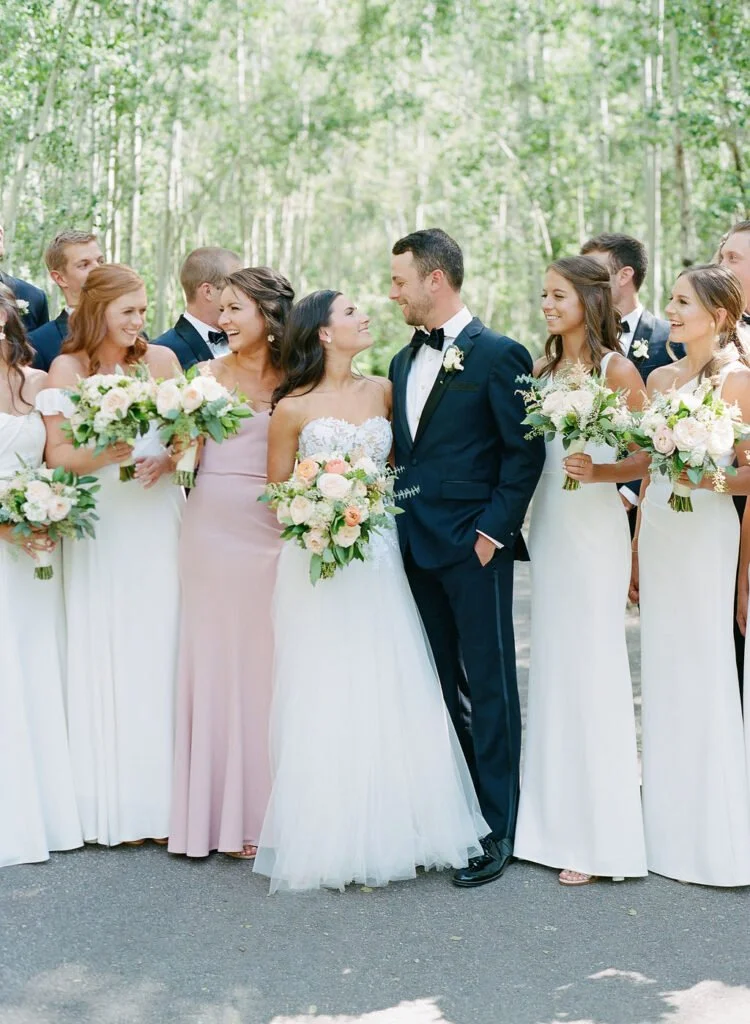 bride and groom standing with their wedding party during their outdoor wedding in New England