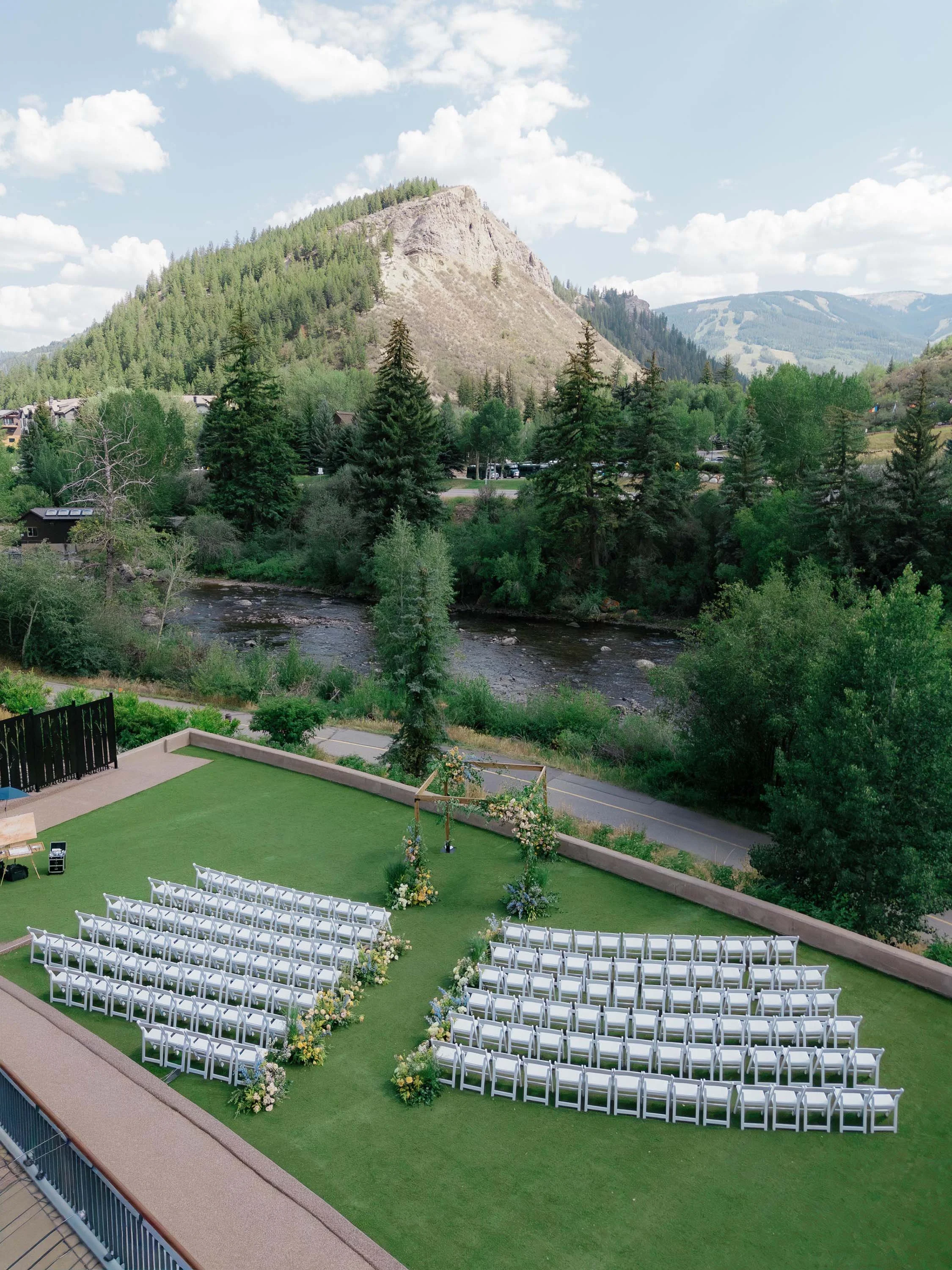 an aerial view of a large outdoor wedding facing the colorado mountains