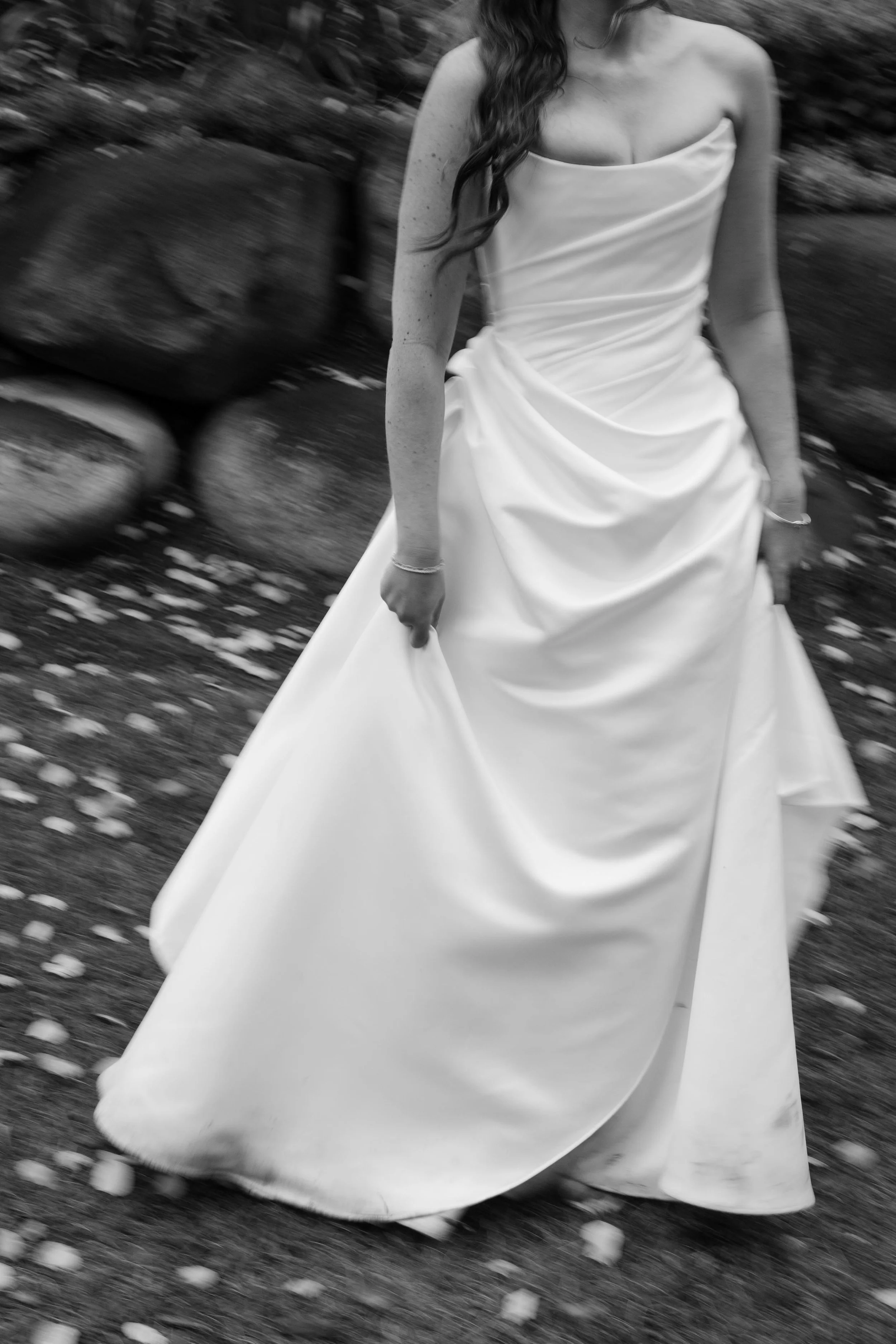 a modern bride holding her dress and walking to her mother