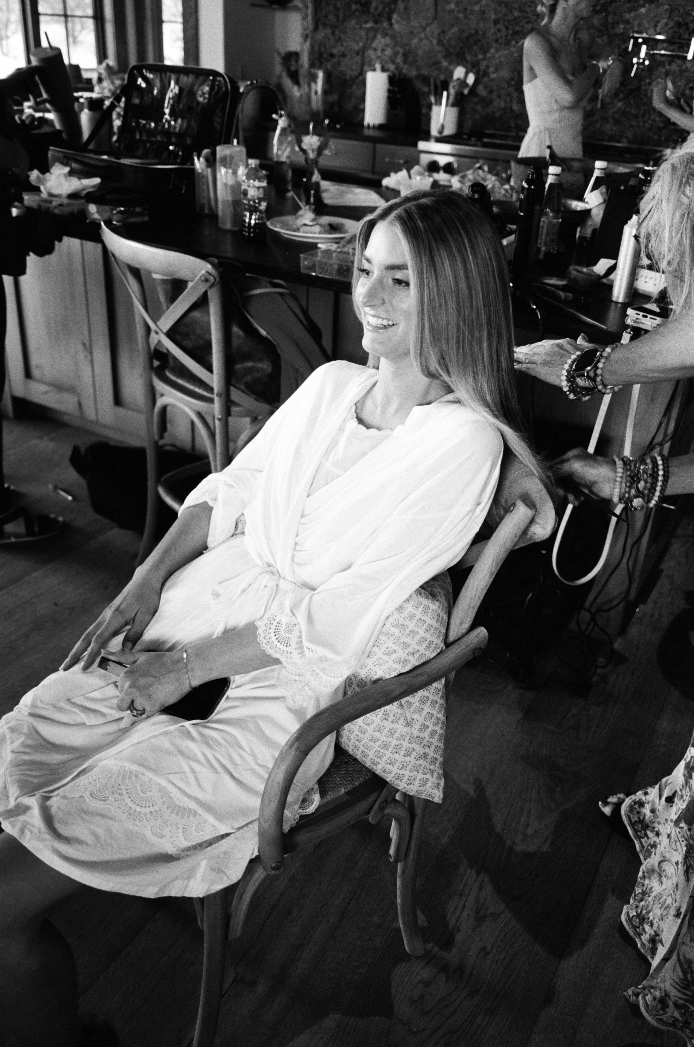 happy bride smiling while getting ready for her wedding in colorado