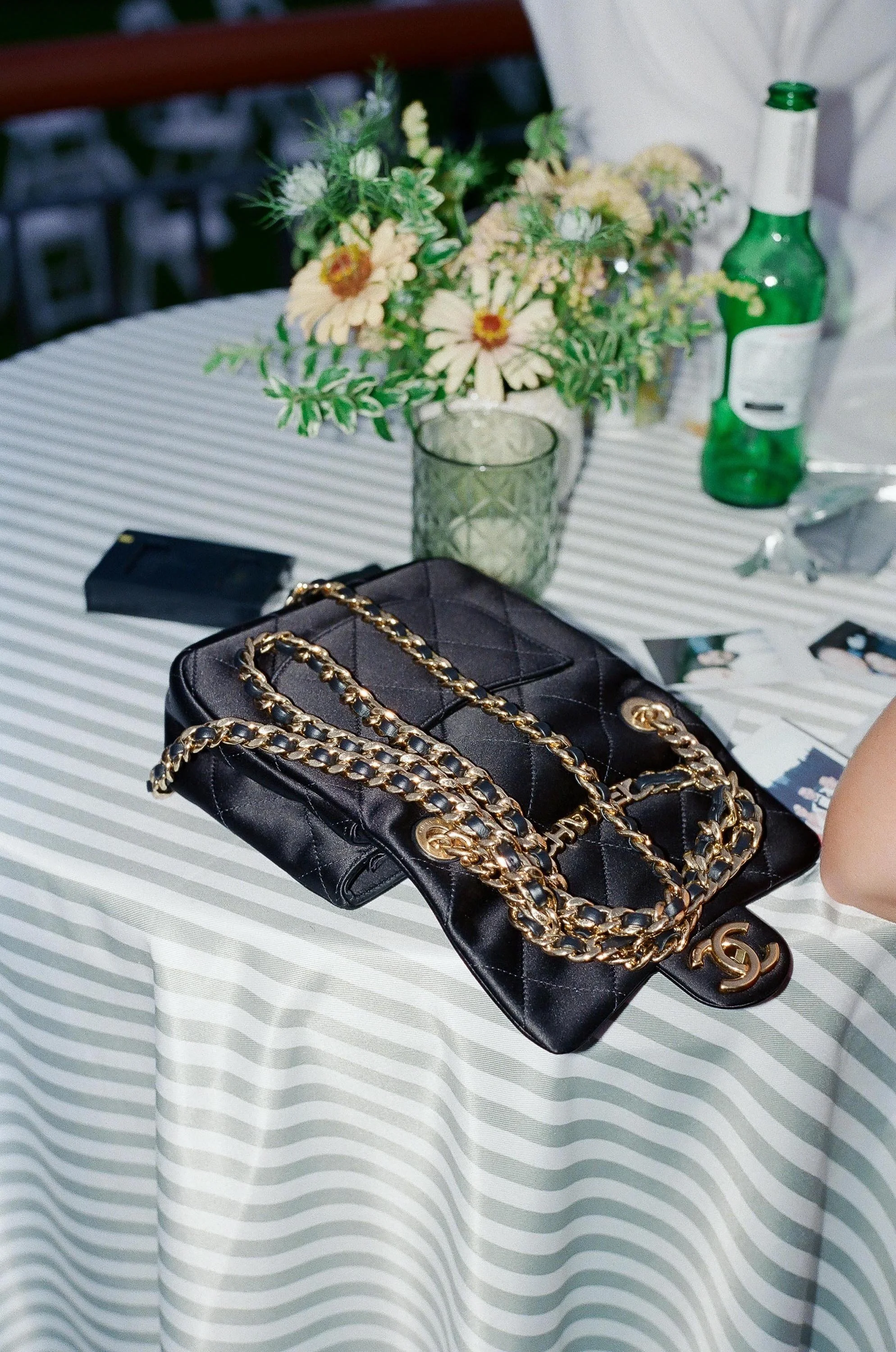 a guest's open chanel bag on top of wedding table