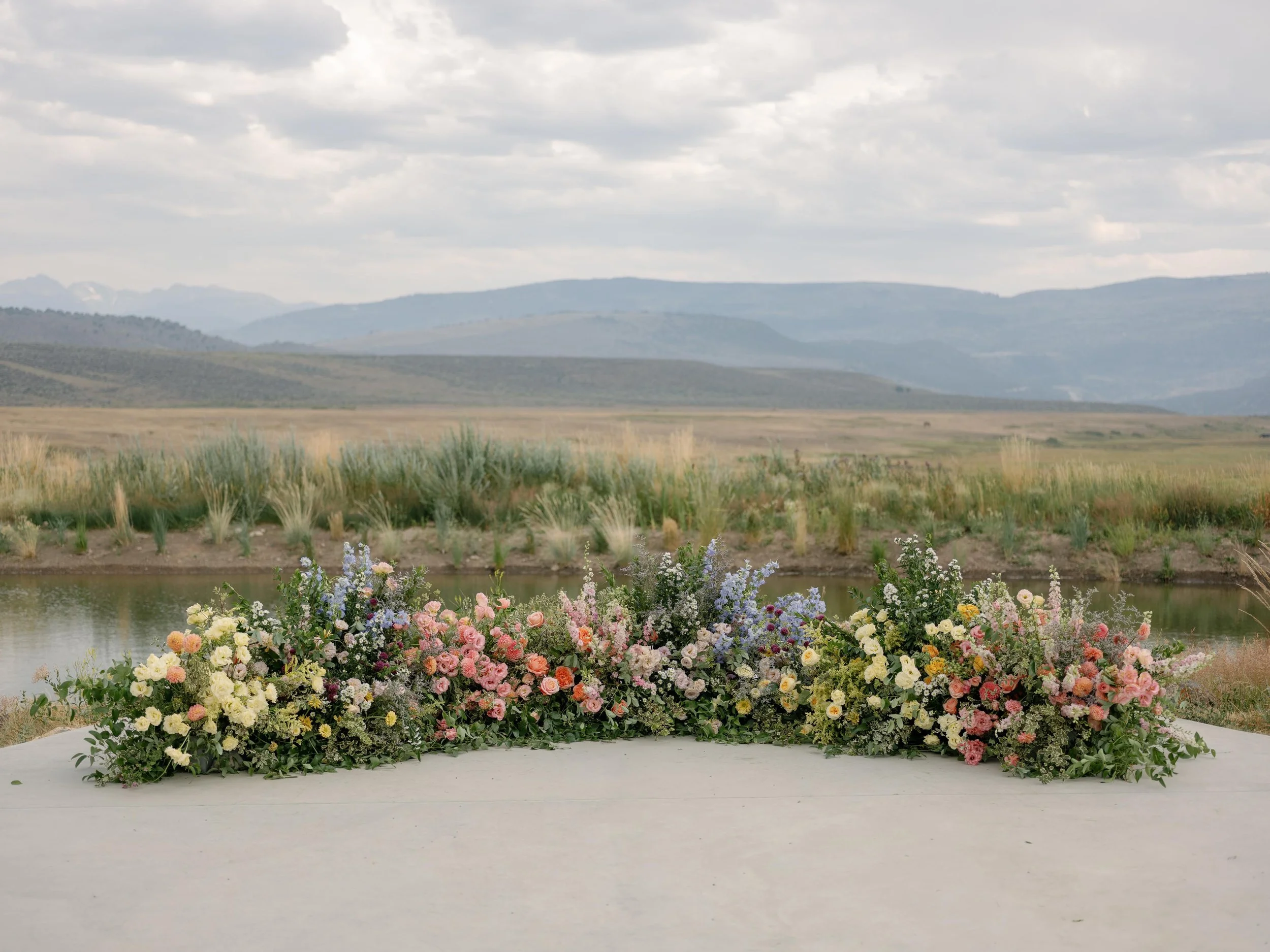 a luxurious wedding altar in front of the colorado mountains