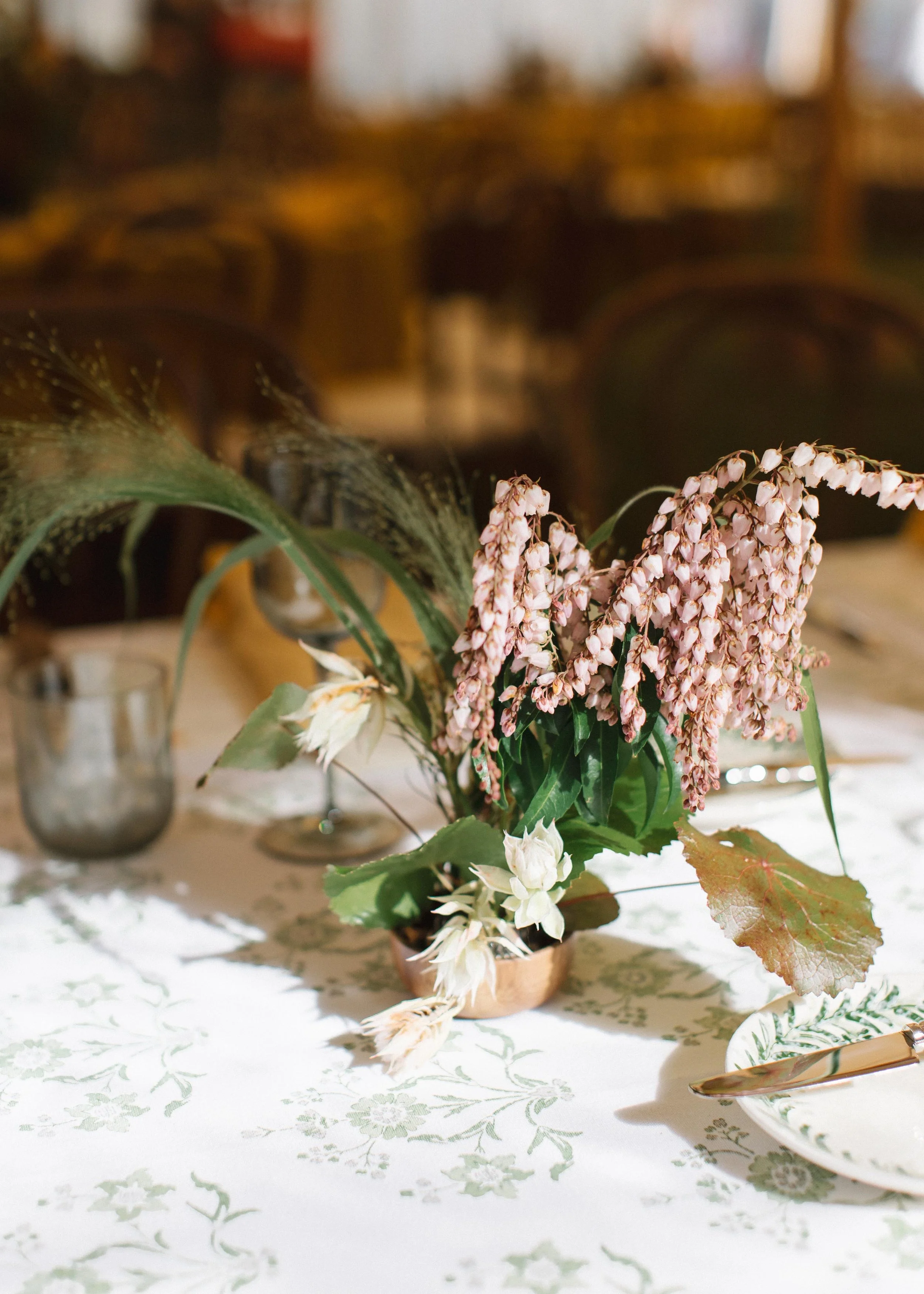 custom pink and green floral arrangement on modern wedding dinner tables in colorado