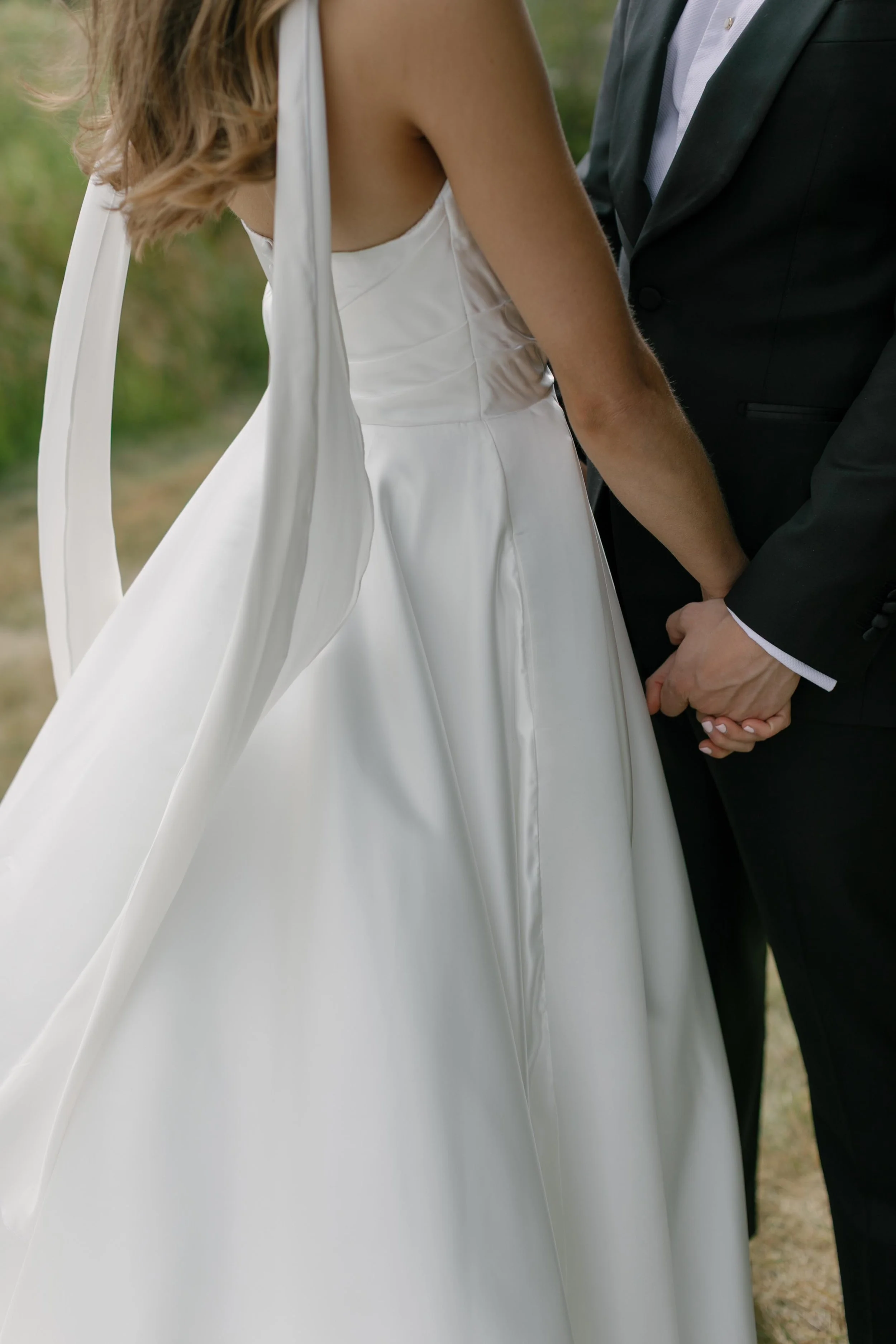 a bride and groom holding hands looking at each other at a luxurious colorado mountains wedding