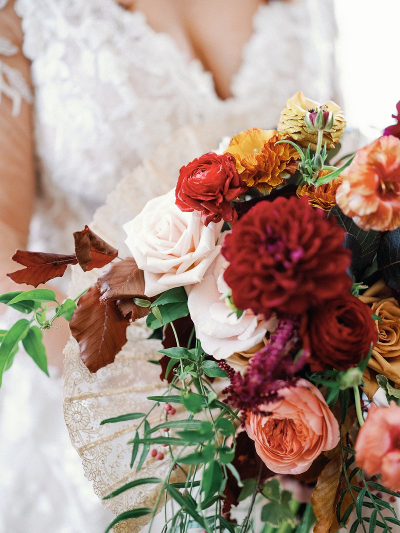 Romantic bridal bouquet with rich autumn blooms and foliage, designed by a New England wedding planner.