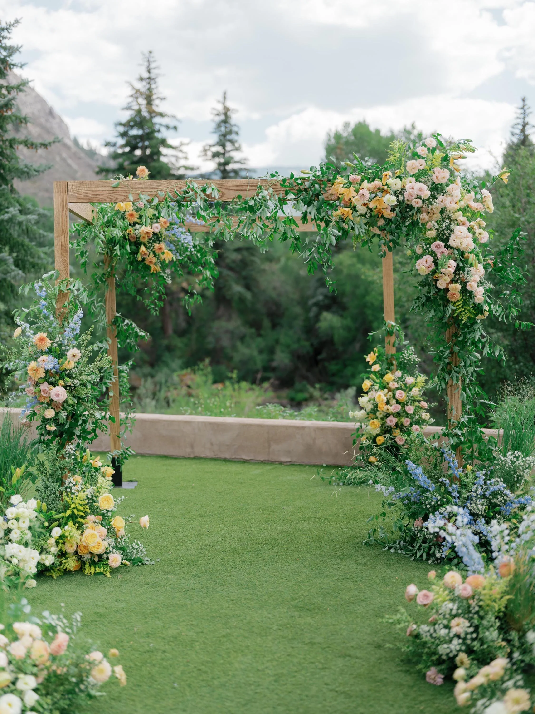a floral pergola altar for a luxurious wedding in beaver creek colorado