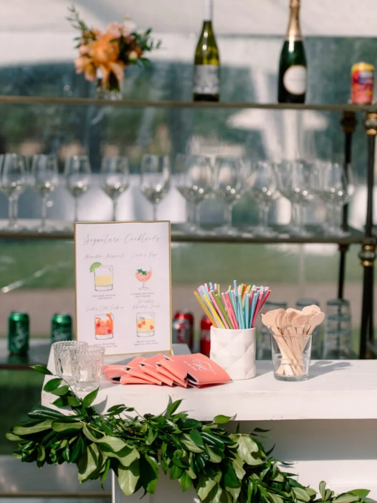 Signature cocktail bar styled through full-service wedding planning with custom signage and curated details.