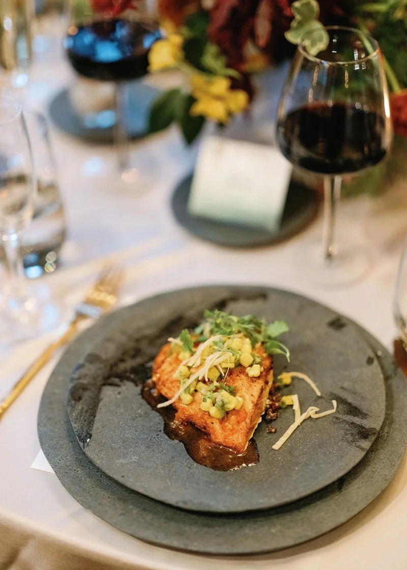 Plated wedding dinner featuring seared salmon and fresh garnish at a New England wedding reception.