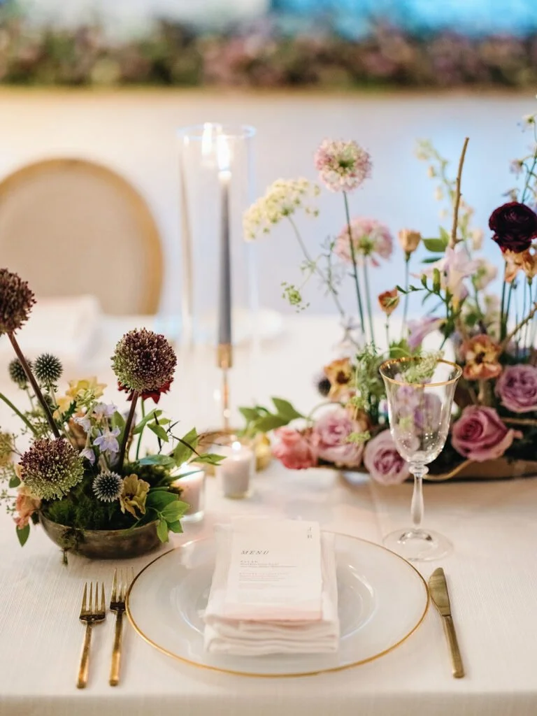 Romantic fall tablescape with soft wedding colors for a fall wedding, including mauve, gold, and ivory.