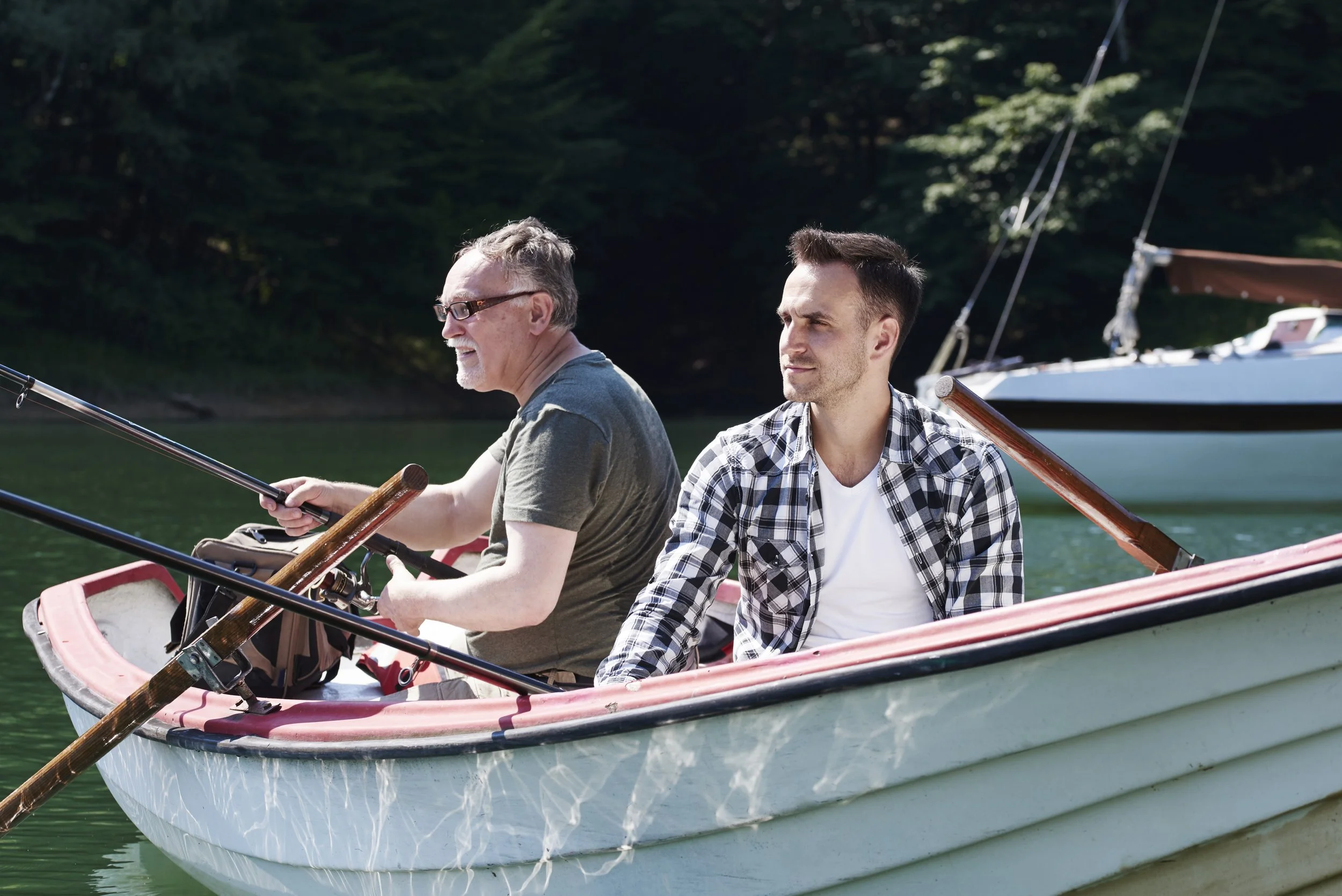 focused-men-with-fishing-rod-sitting-boat.jpg