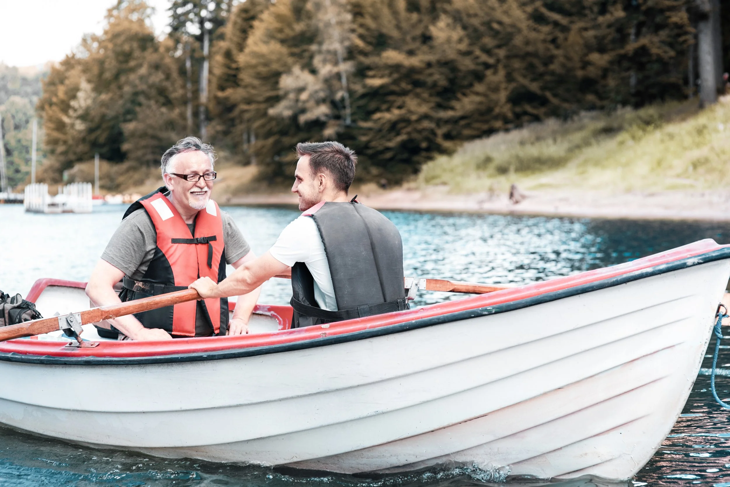 two-men-rowing-boat-tranquil-lake.jpg