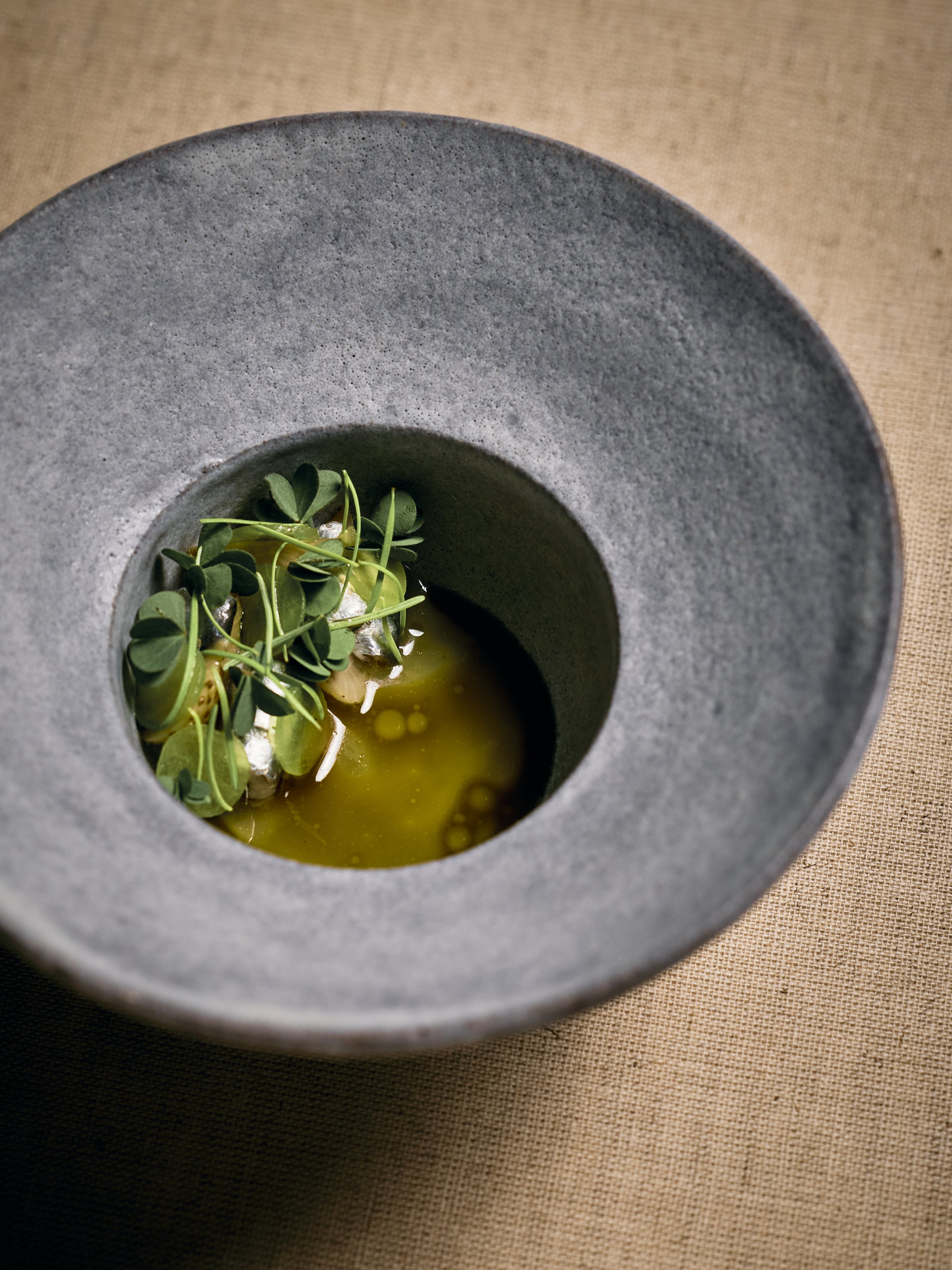 Anchovies pickled in elderflower vinegar with sour apples and green oxalis.