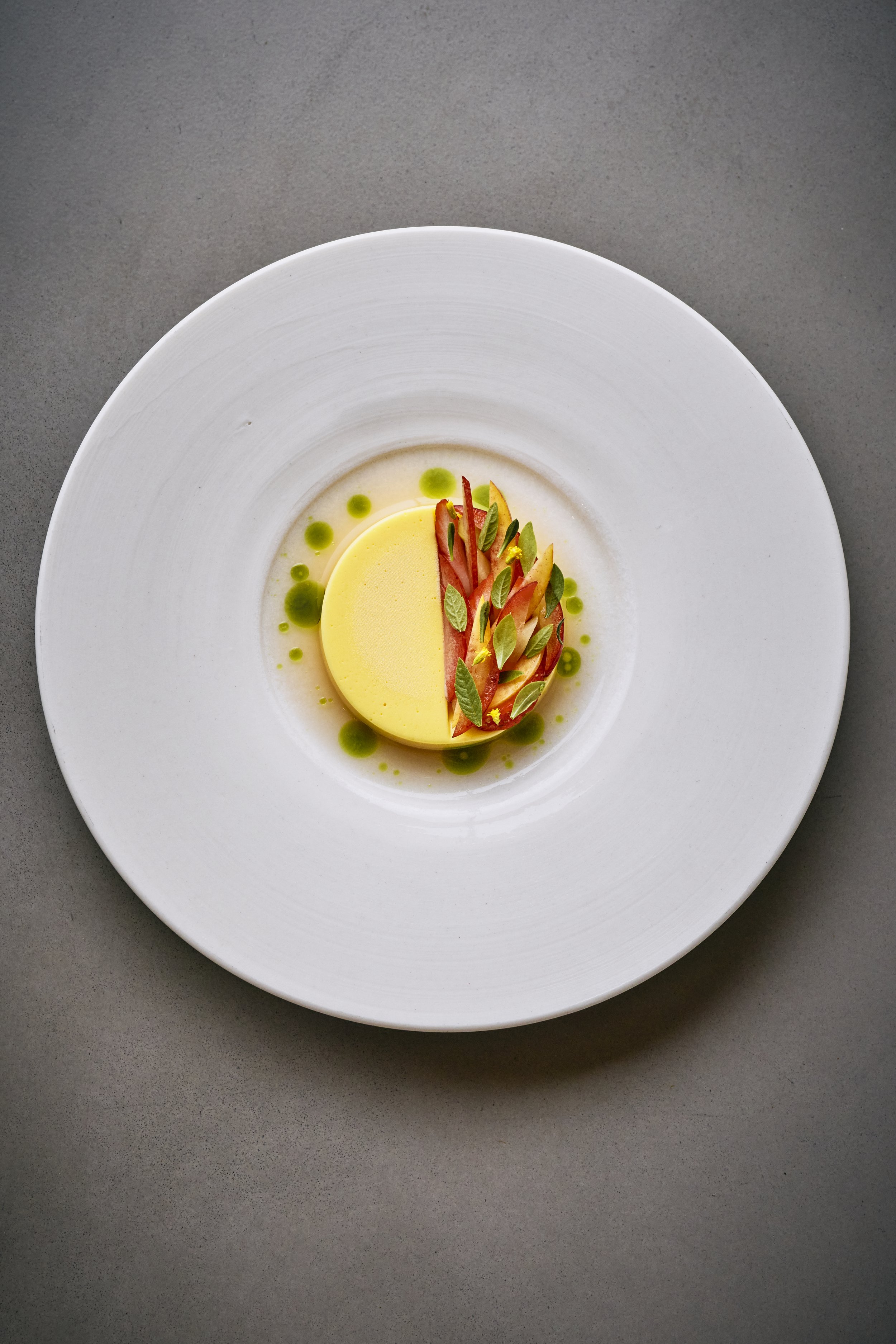 Clotted cream with stone fruits, grilled peach consommé and strawberries.