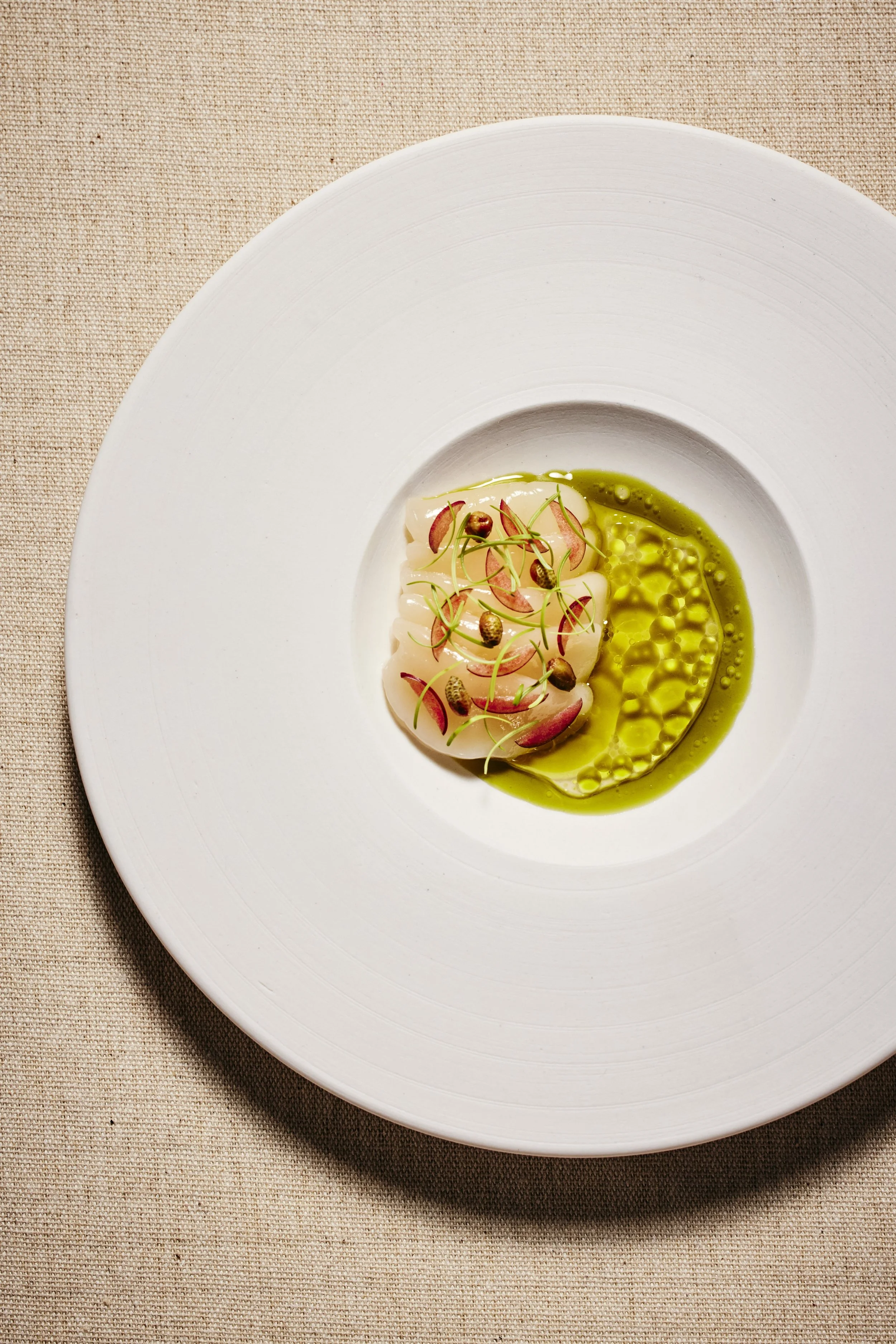 Scallops from Maine with unripe plums and pickled pine pollen.